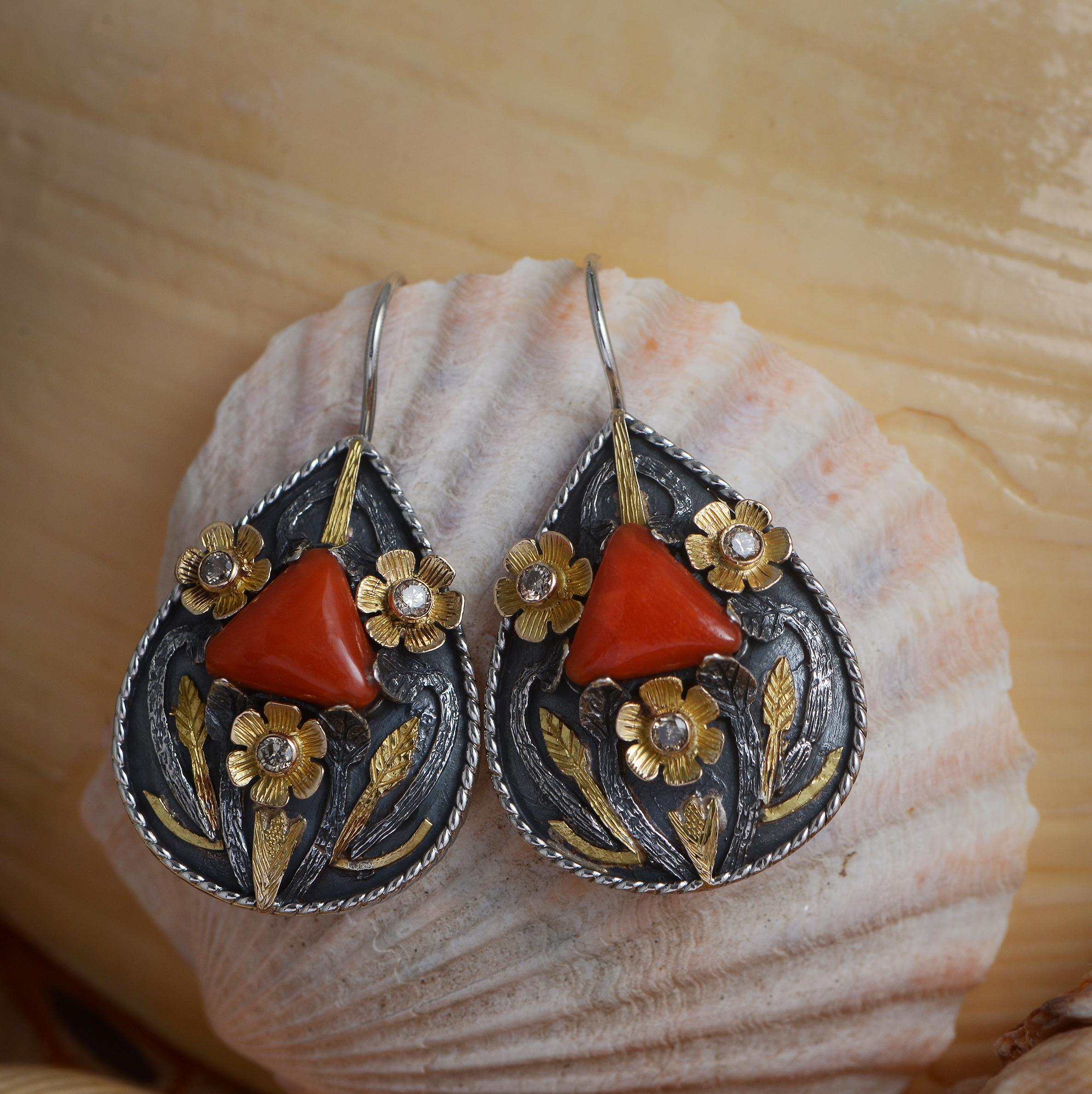 

These divine one of a kind earrings have been handmade in our workshops. We have used intricate hand engraving work using botanical motifs in 18kt gold and oxidized sterling silver, and embedded the earrings with coral and diamonds.

Earrings