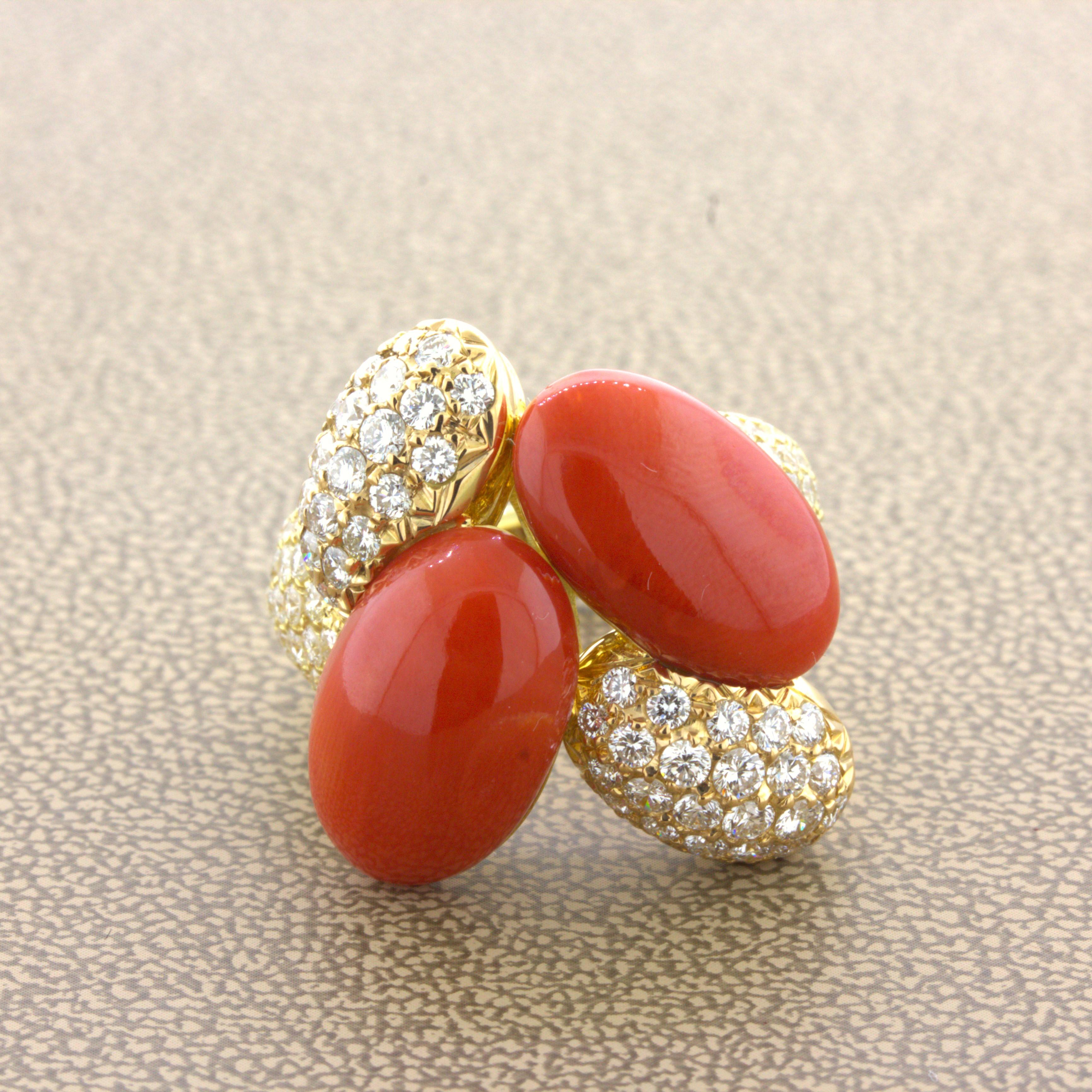 A fun and stylish cocktail ring featuring 2 pieces of fine natural red coral. They are lozenge shaped and have excellent luster and color. They are complemented by 2.47 carats of round brilliant-cut diamonds set around the coral and the ring