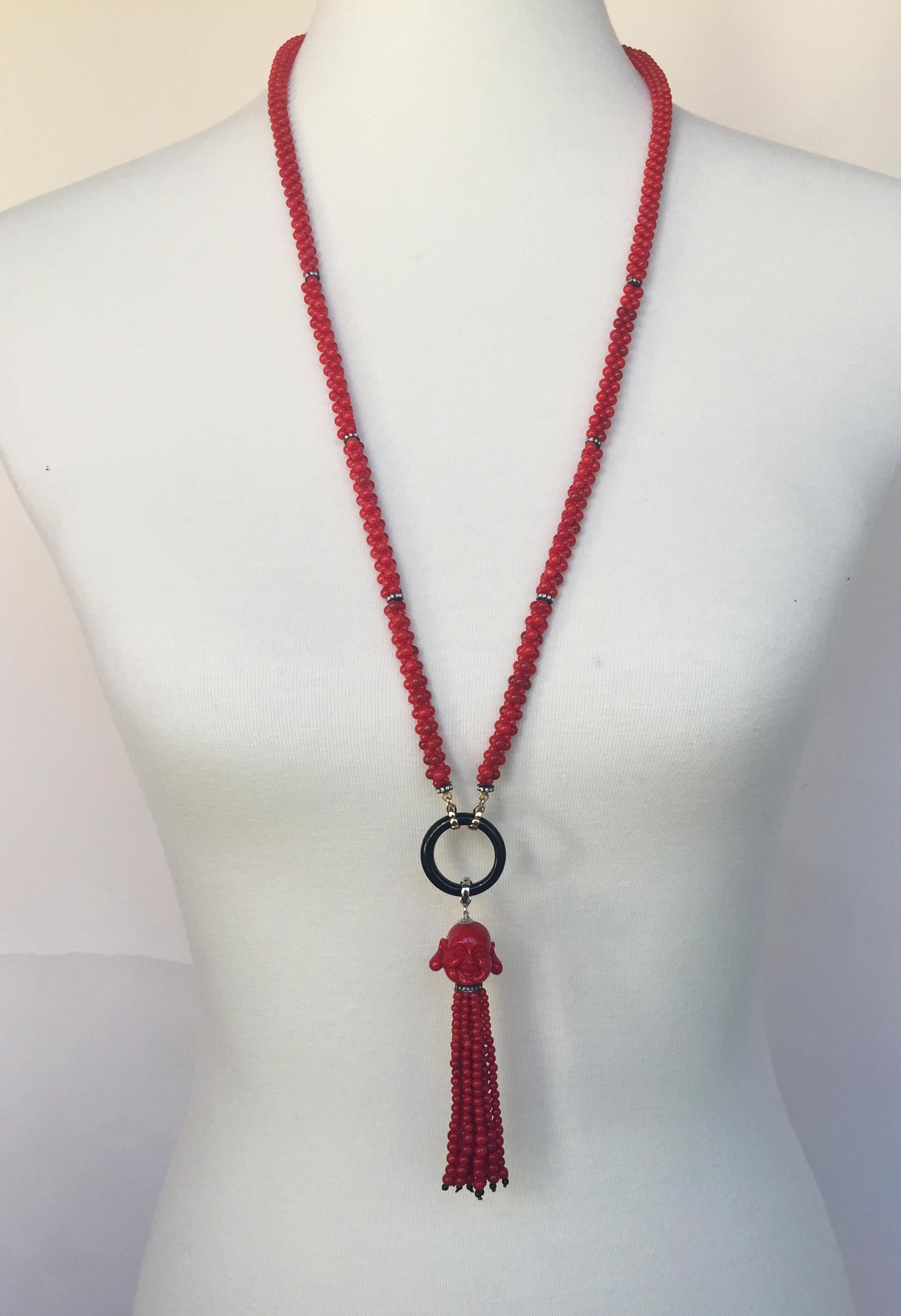 This coral, diamond, and onyx necklace with coral Buddha tassel and 14k gold is stunning. The brilliant red coral beads and shimming silver and diamond encrusted roundels are a striking combination. The black onyx ring highlights this beautiful