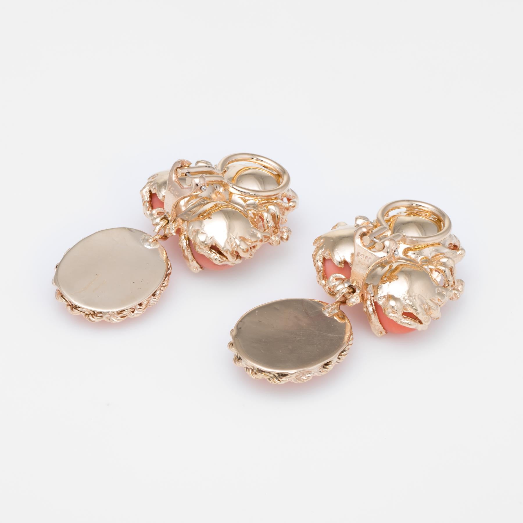 Finely detailed pair of vintage drop earrings (circa 1950s to 1960s), crafted in 14k yellow gold. 

6 pieces of natural coral measure 7mm each (upper) and 13.5mm x 10.5mm (lower). The total coral weight is estimated at 25 carats. Two estimated 0.15