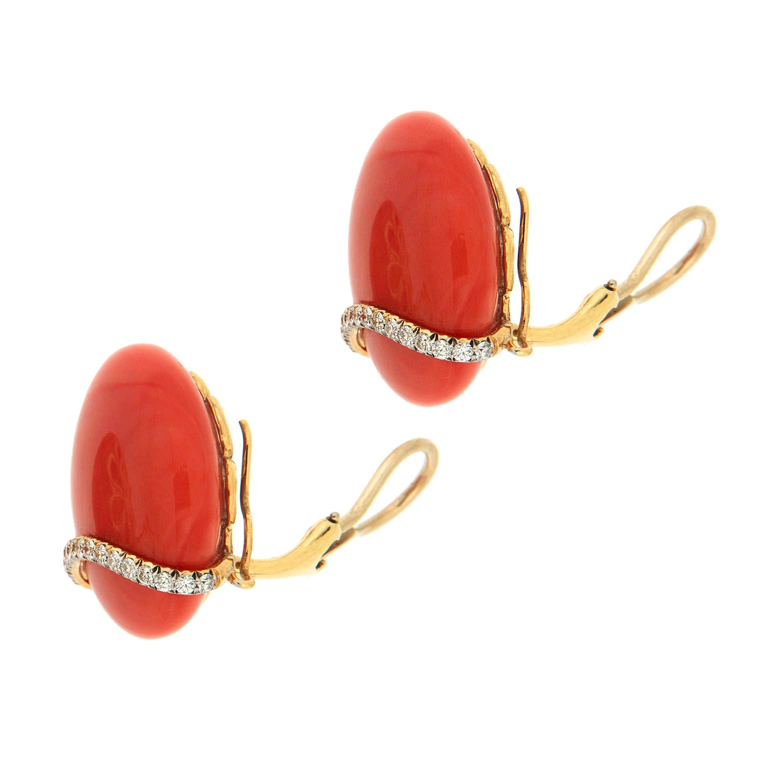 Ocean and earth come together in these earrings. Red coral representing the sea is carved into 25mm round cabochons and polished until gleaming. Round brilliant cut diamonds are the land element, mounted in a curved line across the coral. The