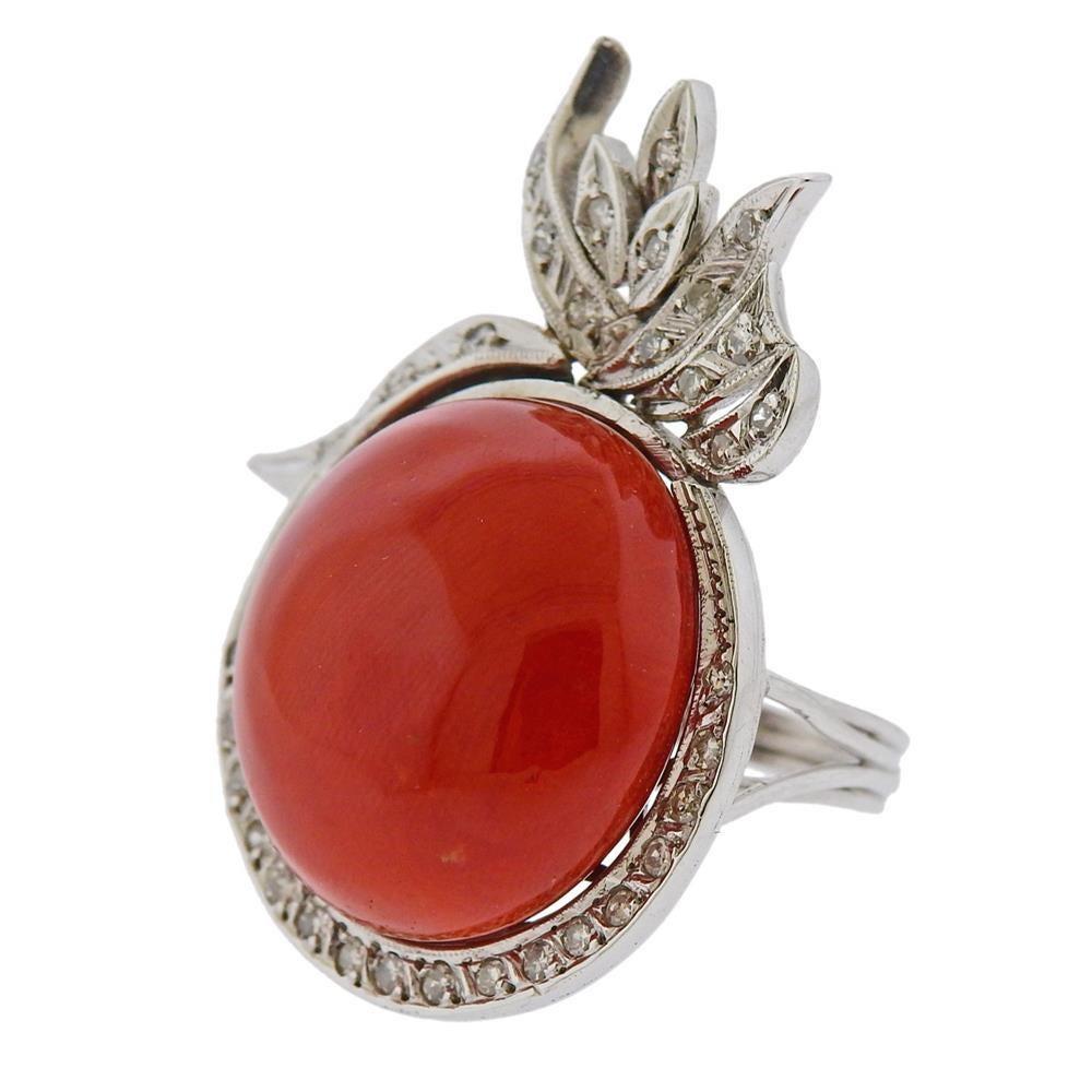 10k white gold cocktail ring, set with 21.1mm coral, surrounded with approx. 0.32ctw in diamonds. Ring size - 6, ring top - 40mm x 26mm. Tested 10k.  Weight 16.7 grams.