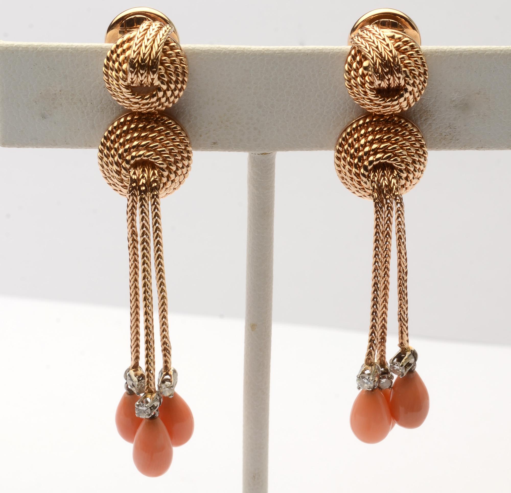 Unusual coral and diamond earrings with a variety of textures and dimensions. The two domes are twisted gold with foxtail over the top to  give the appearance of being a continuation of the three foxtail dangles. The pear shaped coral stones are