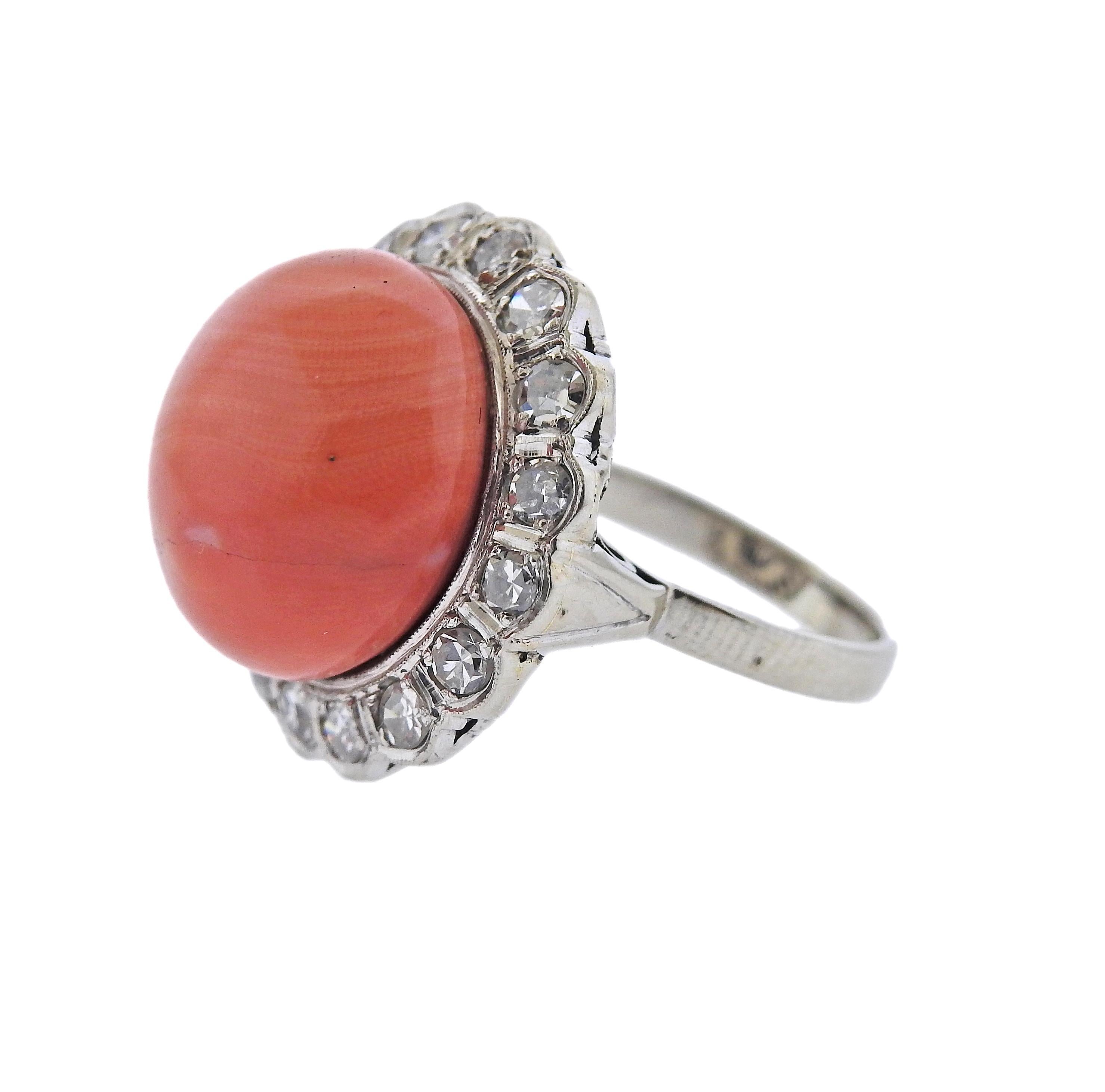 Vintage 14k gold cocktail ring, with center 15mm coral, surrounded with approx. 0.80ctw in diamonds. Ring size - 5.5, ring top is 20mm in diameter. Marked 14k. Weight - 7.5 grams.