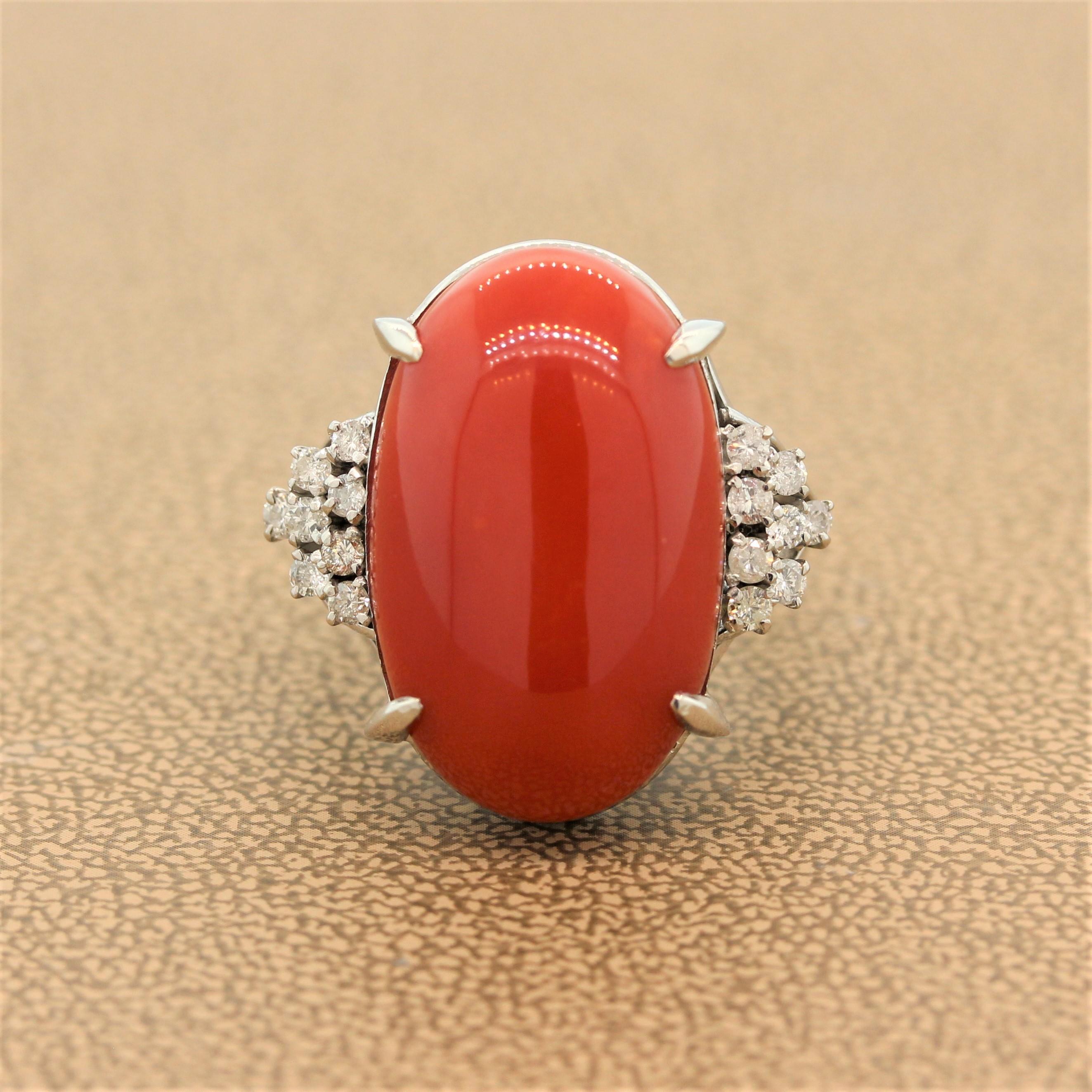 A bold colored stone ring featuring an elongated piece coral. The cabochon coral has 0.38 carats of round cut diamonds clustered in a platinum setting on each of its shoulders. This rings elegance lies in its simplicity and quality.

Ring Size 8.5