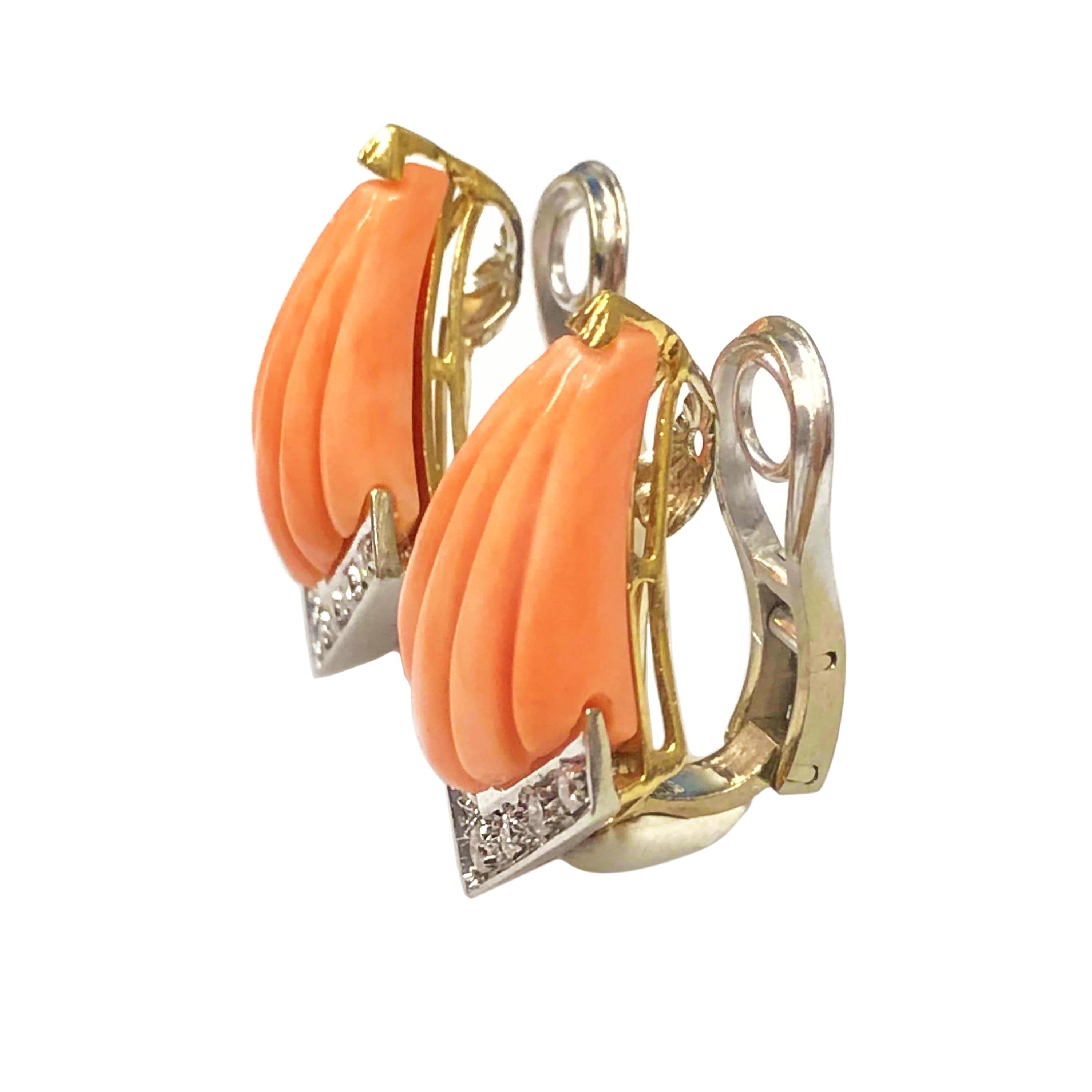 Circa 1970s 18K White and Yellow Gold Earrings, Set with Fan Shaped Scalloped carved Coral and further set with Round Brilliant cut Diamonds totaling 1/2 carat. The earrings measure 1 inch in length X 3/4 inch wide. Clip backs to which a post can be