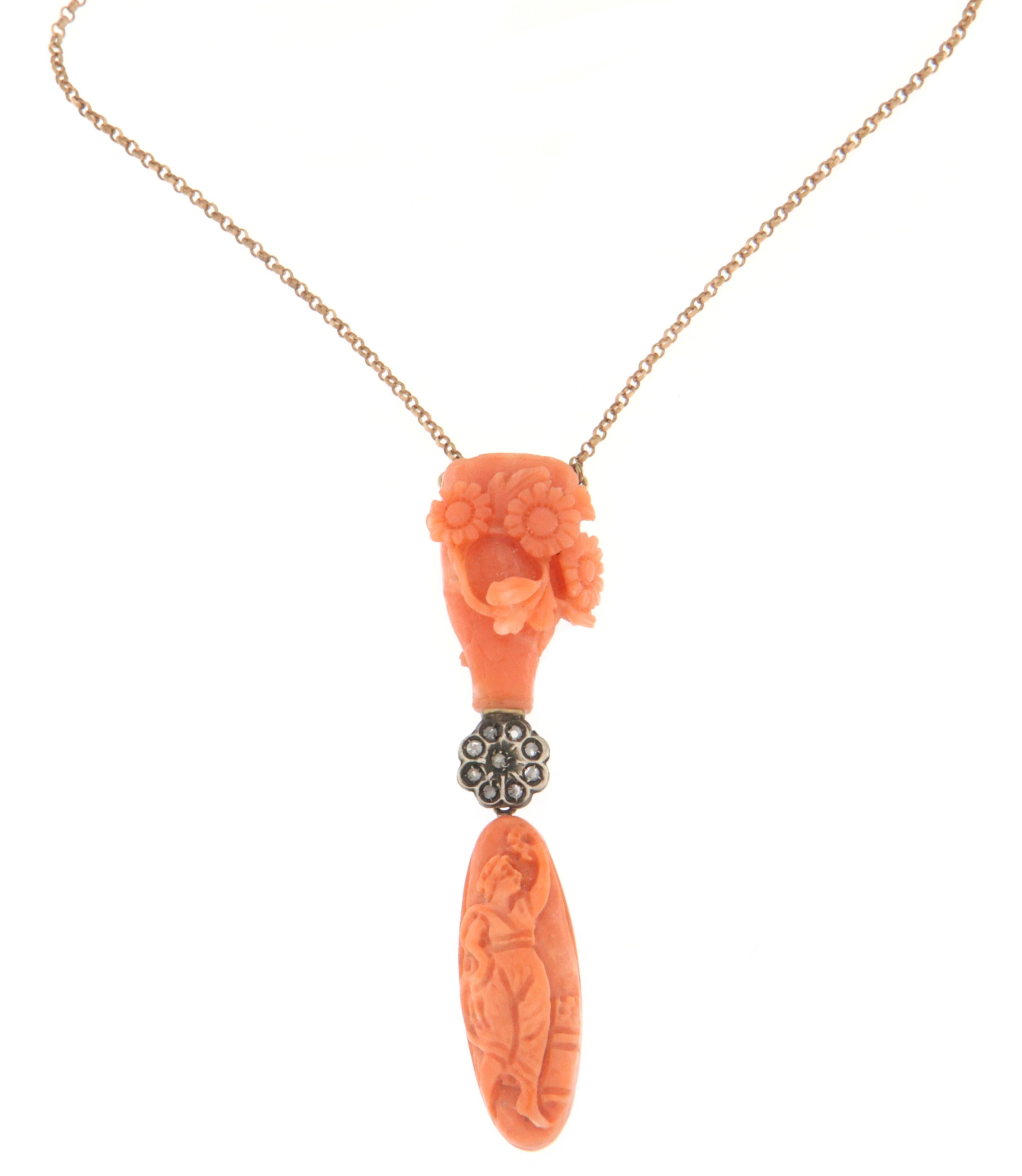 Magnificent necklace made by skilled Neapolitan goldsmiths that recalls the charm of the Baroque era, the jewel made in 14 karat yellow gold and 800 thousandths silver mounted with natural coral and old cut diamonds.

Total Weight of the necklace