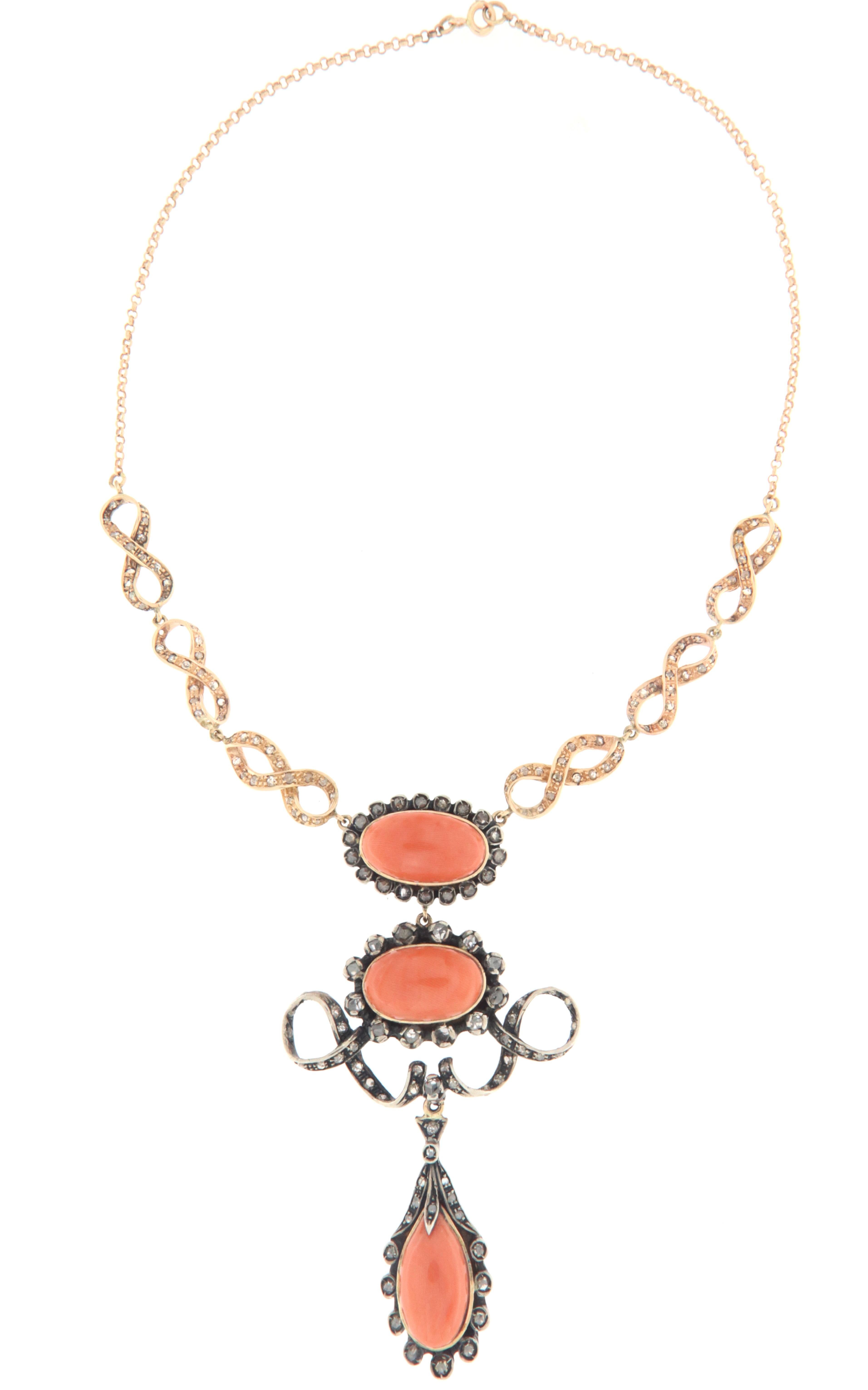 Magnificent necklace made by skilled Neapolitan goldsmiths that recalls the charm of the Baroque era, many intertwining flourishes characterize the design of this jewel made in part with 800 thousandths silver rose cut diamonds,natural coral and 14