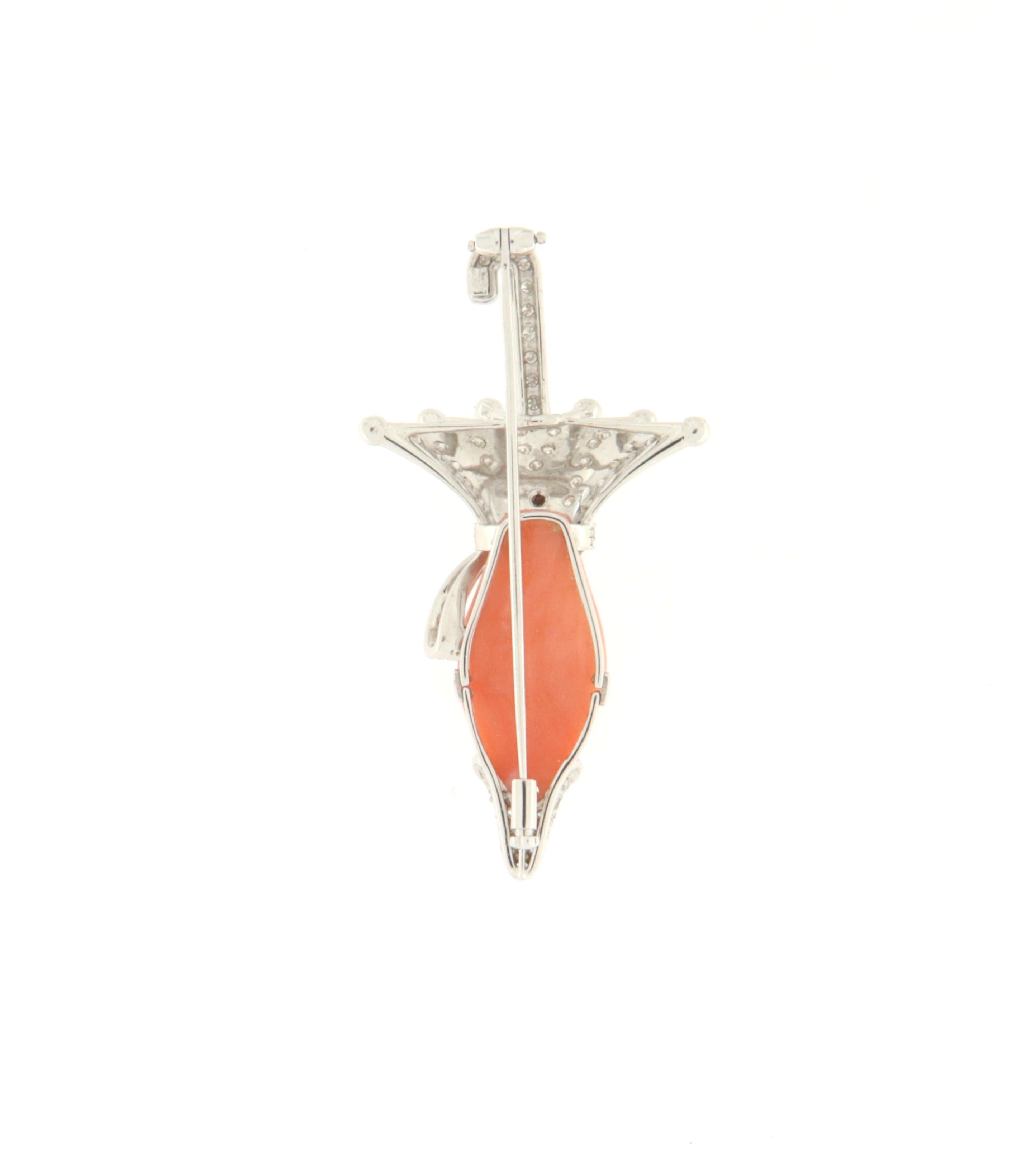 Beautiful Brooch umbrella of 18 Karat white gold and studded with natural white brilliants with one piece of coral.
The artist who created this brooch indulged himself in reproducing the umbrella using one very simple engraved coral ovals as the