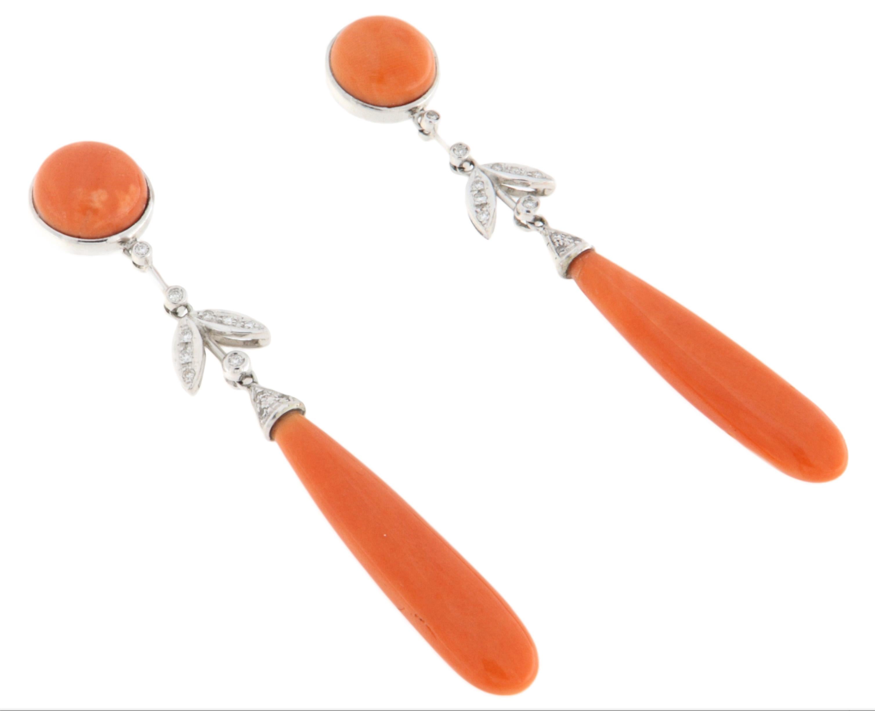 Elegant drop earrings crafted in 18-karat white gold, adorned with brilliant-cut diamonds and high-quality natural coral. The design gracefully blends the brightness of diamonds with the warm, rich hue of coral, creating a striking contrast full of