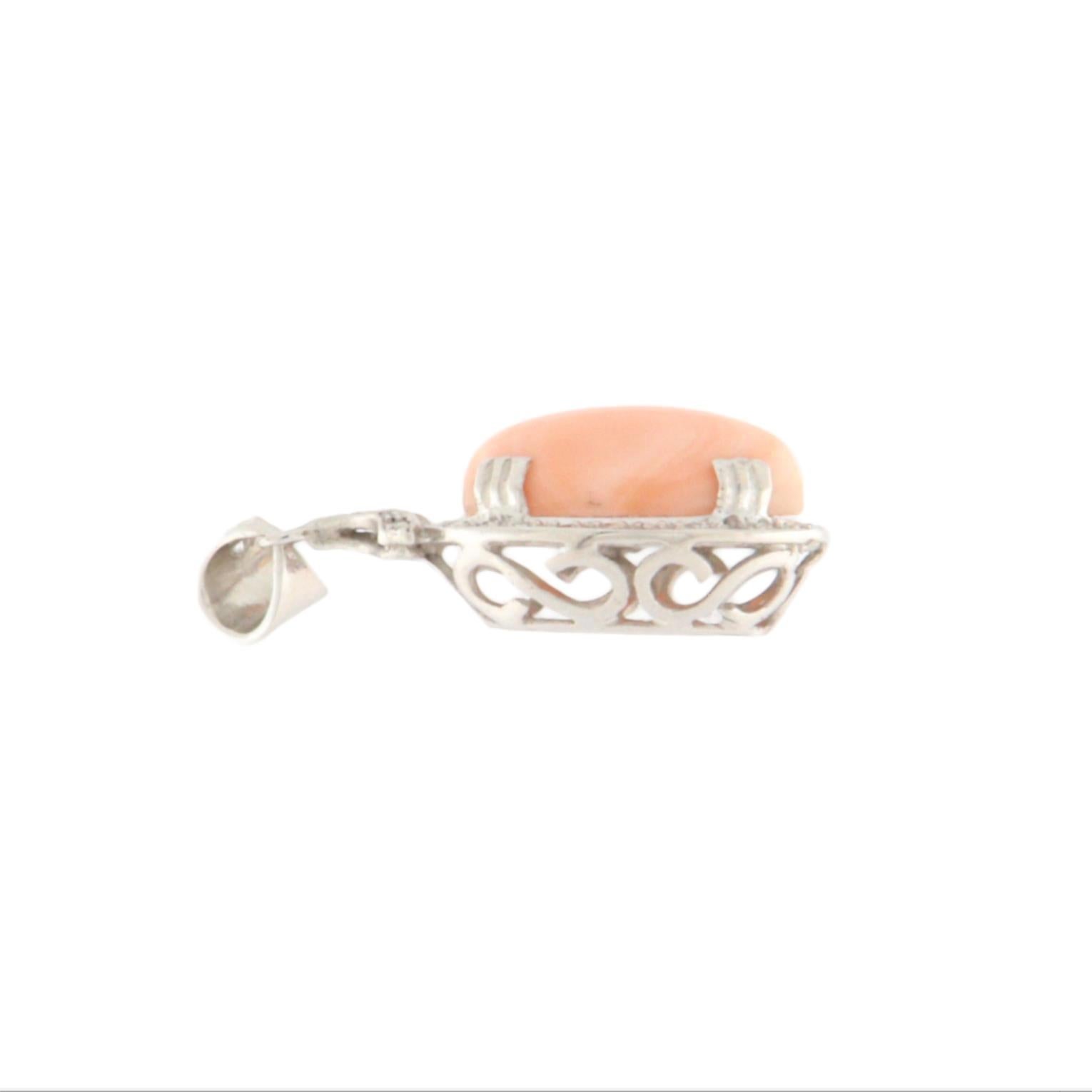 Refined and timeless, this pendant is crafted in 18-karat white gold and adorned with a fine natural pink coral, beautifully framed by a halo of brilliant-cut diamonds. The softness of the coral, with its delicate peach and blush tones, blends
