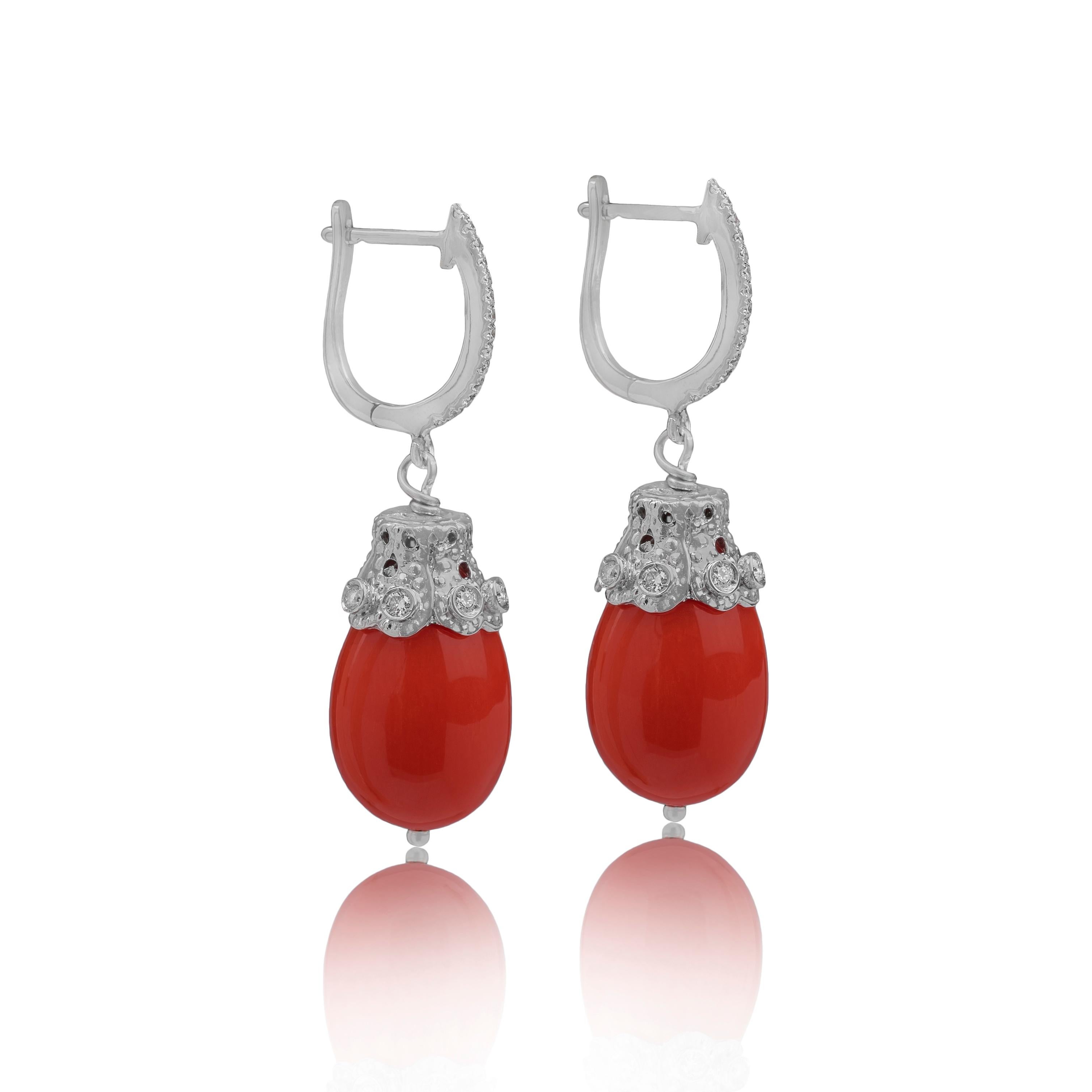 These earrings with coral and diamonds are made in Italy by Fanuele Gioielli.
Each earring, with lever-back closure, is made of a drop-shaped coral pendant with a small decoration of white gold and brilliant cut white diamonds.

Gold total content