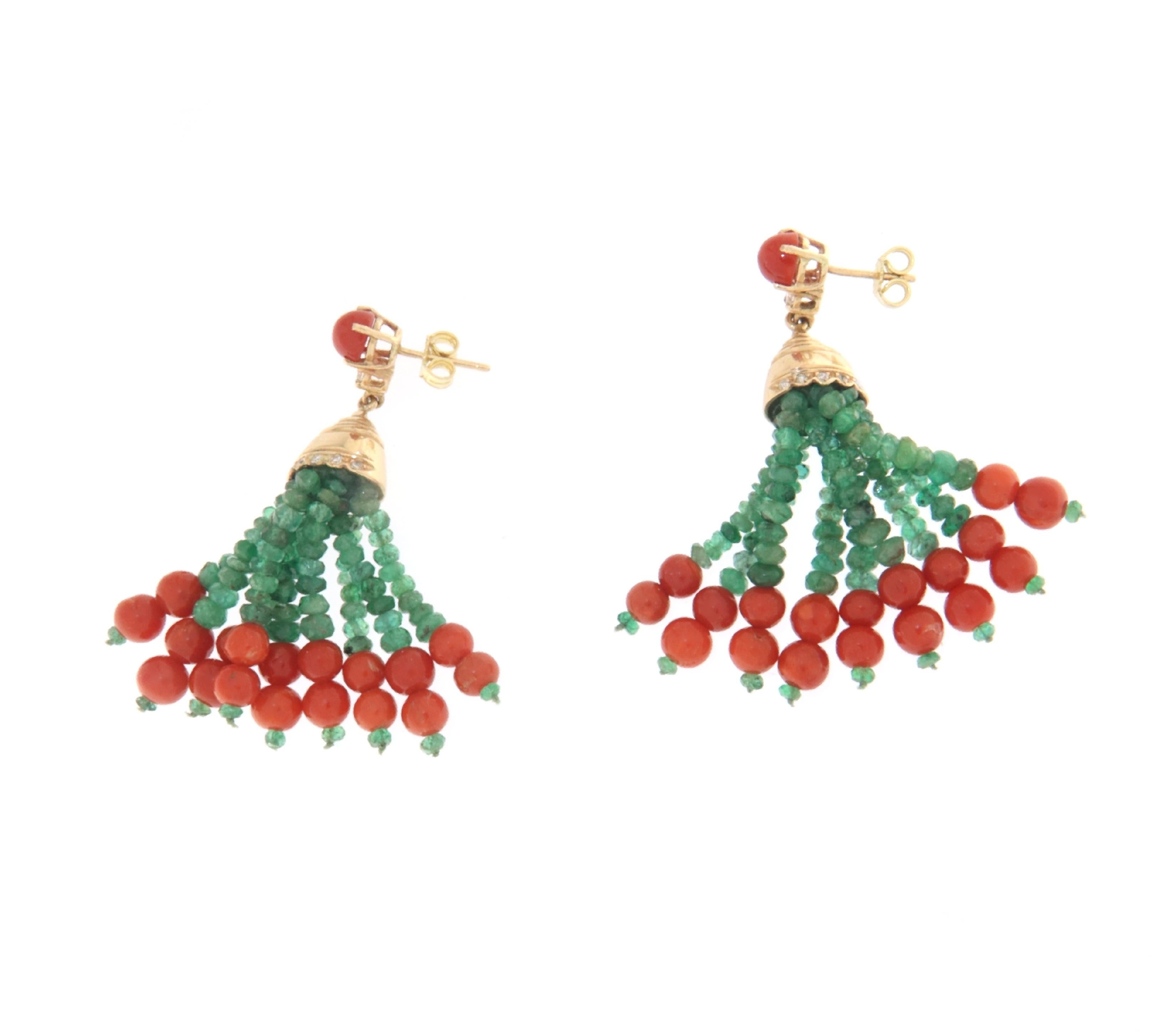 These exquisite earrings are a testament to classic elegance and vibrant design, crafted in 14-karat yellow gold and adorned with a stunning combination of emeralds, coral beads, and brilliant diamonds. Each earring features a cascading design that