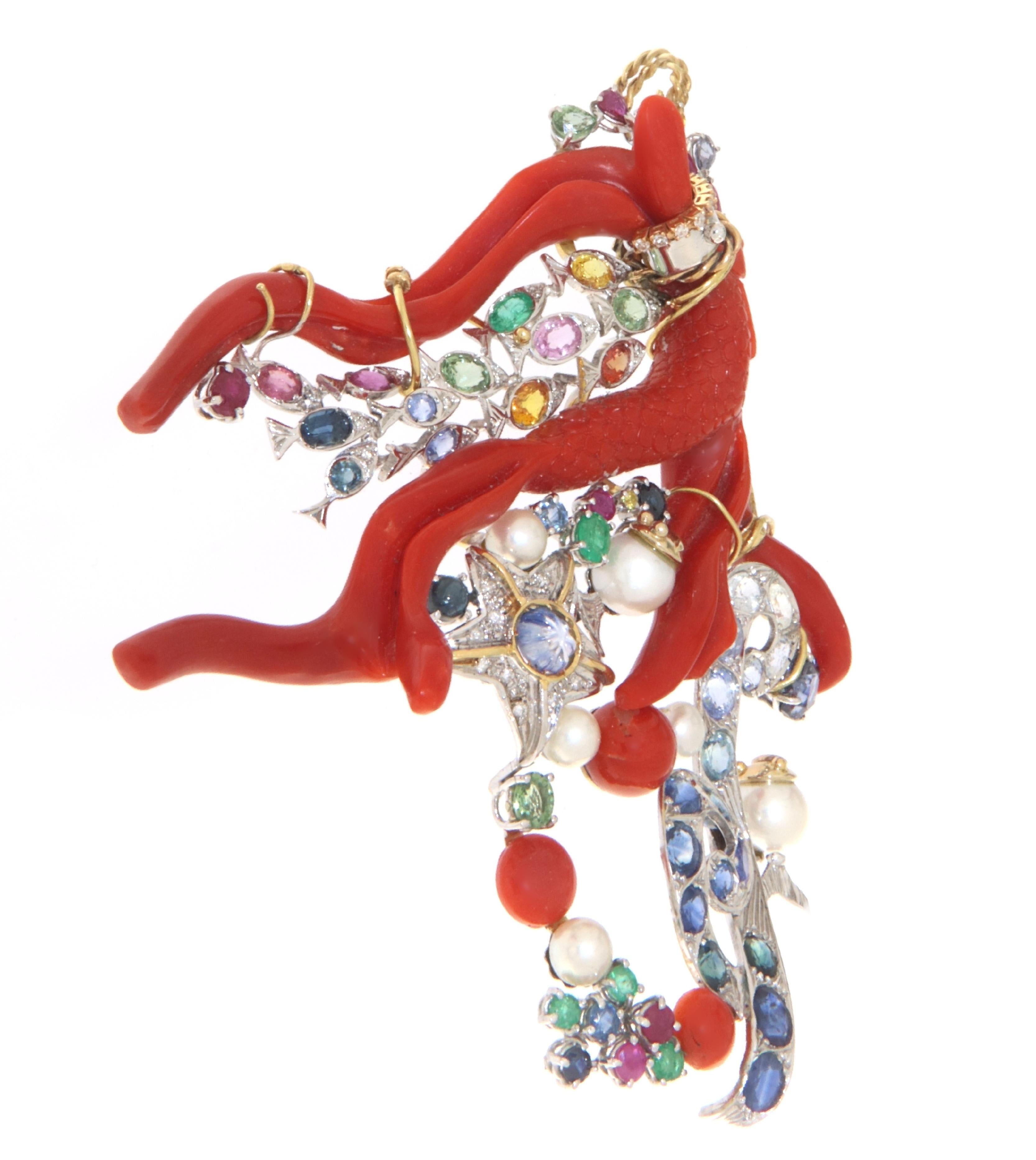 Artistic masterpiece of pure Southern Italian manufacturing, precisely Neapolitan, a magnificent pendant for necklaces in the shape of a tropical fish reproduced in natural coral from the seas of Sardinia surrounded by precious stones of every shape