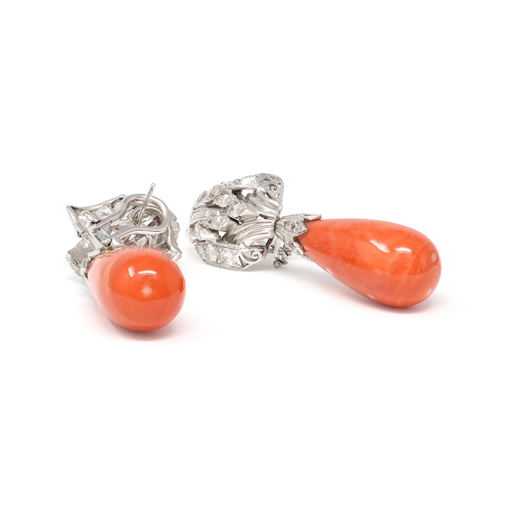 An impressive pair of coral drop dangling earrings with diamonds. Hand made in platinum circa 1950, the earrings have an estimated weight of 3.20 carats of diamonds GH color and VS-SI clarity. The coral drops are natural color with no indication of