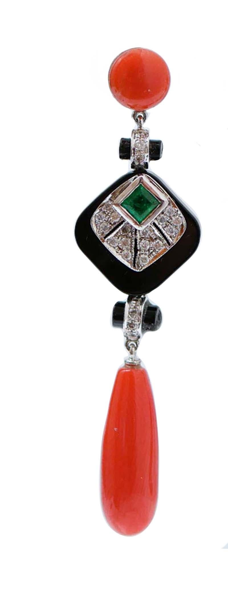Amazing earrings in platinum structure mounted with a coral in the upper part; in the middle, an onyx  and, on it, a structure studded with a central emerald surrounded by diamonds. Below, another structure with diamonds and onyx and, as pendant, a