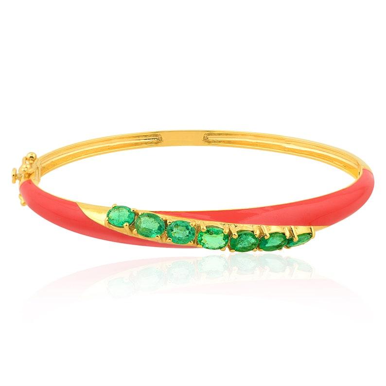 A coral enamel bangle bracelet handmade in 18K yellow gold & set in 2.27 carats of emerald. We can also design in custom enamel color.

FOLLOW MEGHNA JEWELS storefront to view the latest collection & exclusive pieces. Meghna Jewels is proudly rated