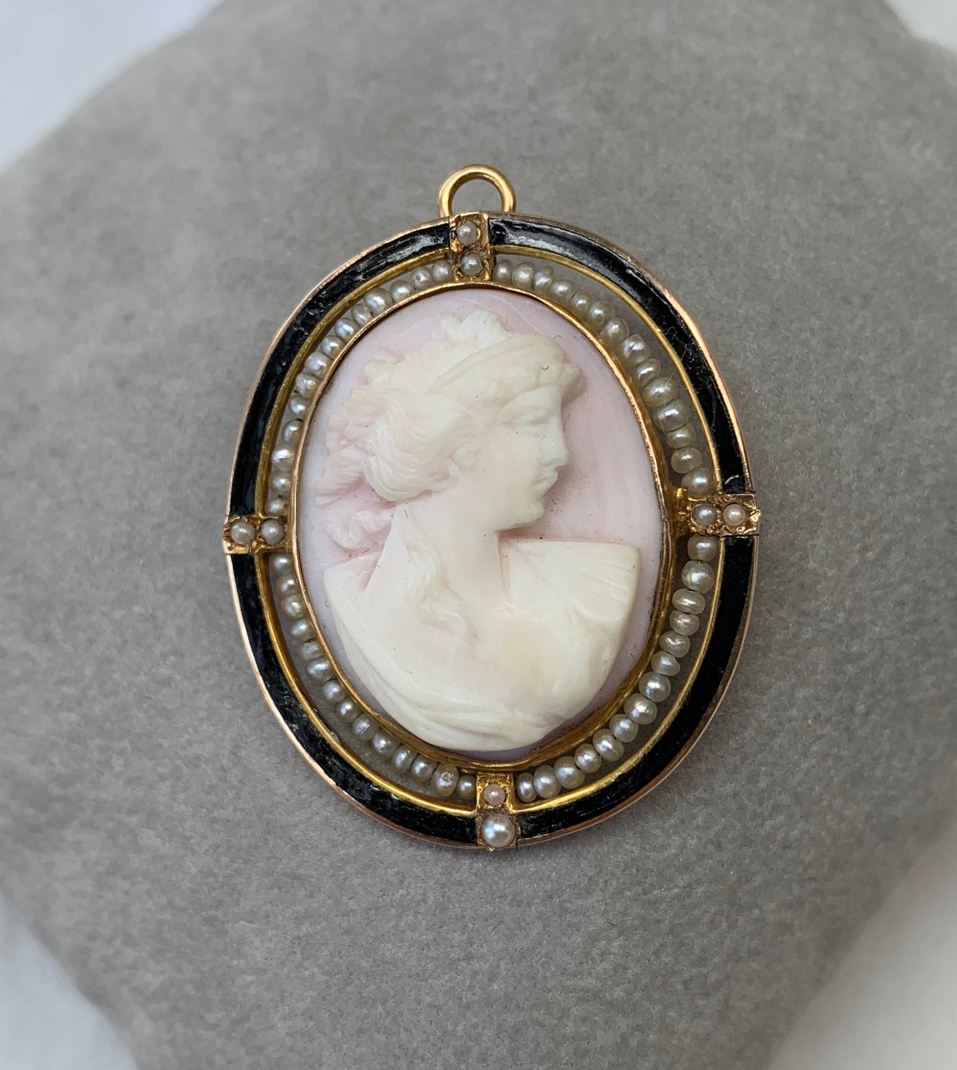 This is an absolutely stunning and very rare antique Victorian - Belle Epoque Pink and Angel Skin Coral Cameo Pendant or Brooch Pin with a hand carved image of a classical goddess woman set in a gorgeous 10 Karat Yellow Gold frame with a halo of