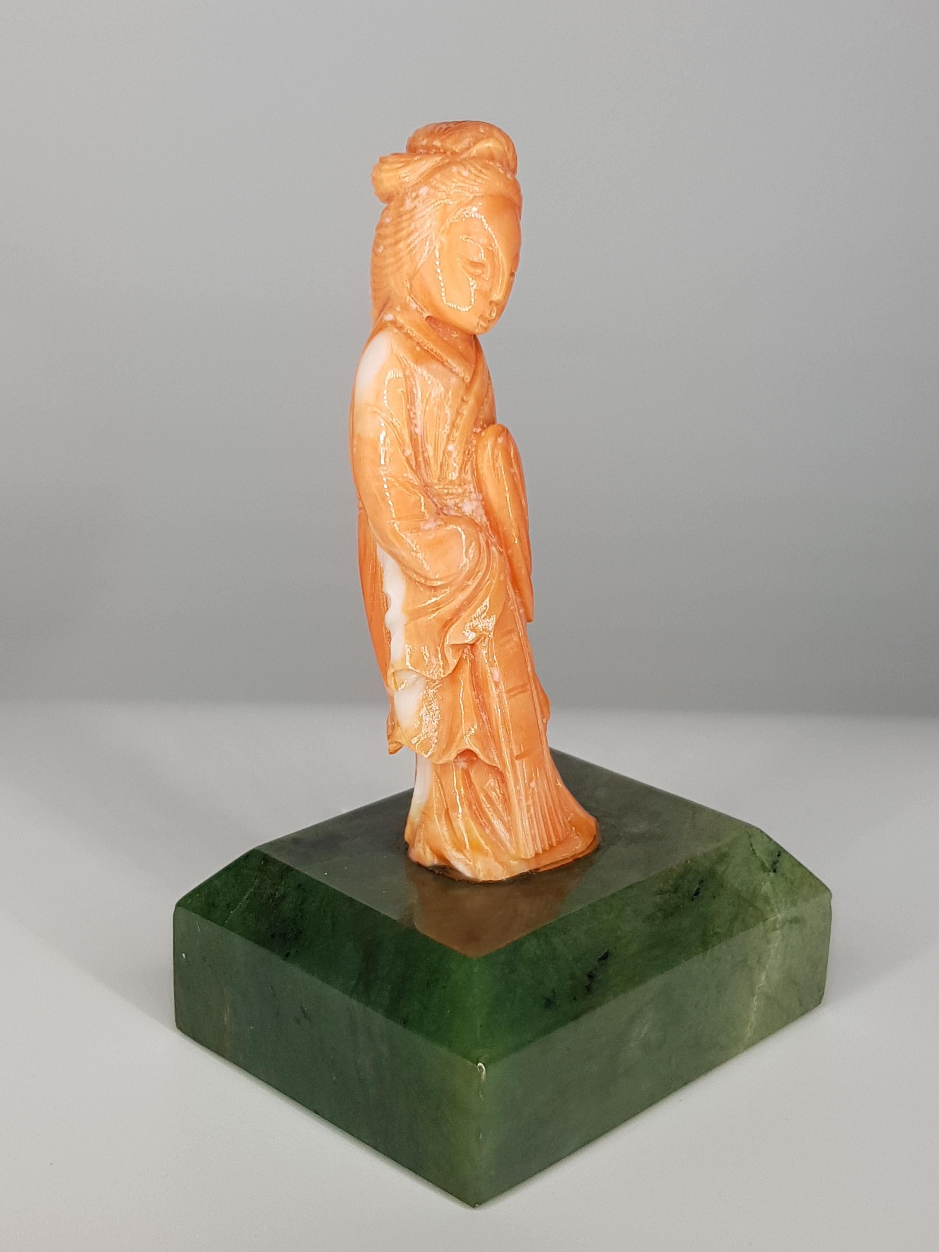 This finely engraved coral Figurine rests on a jade base.
It is an exquisitely crafted piece dating from the early twentieth century

Unique Piece