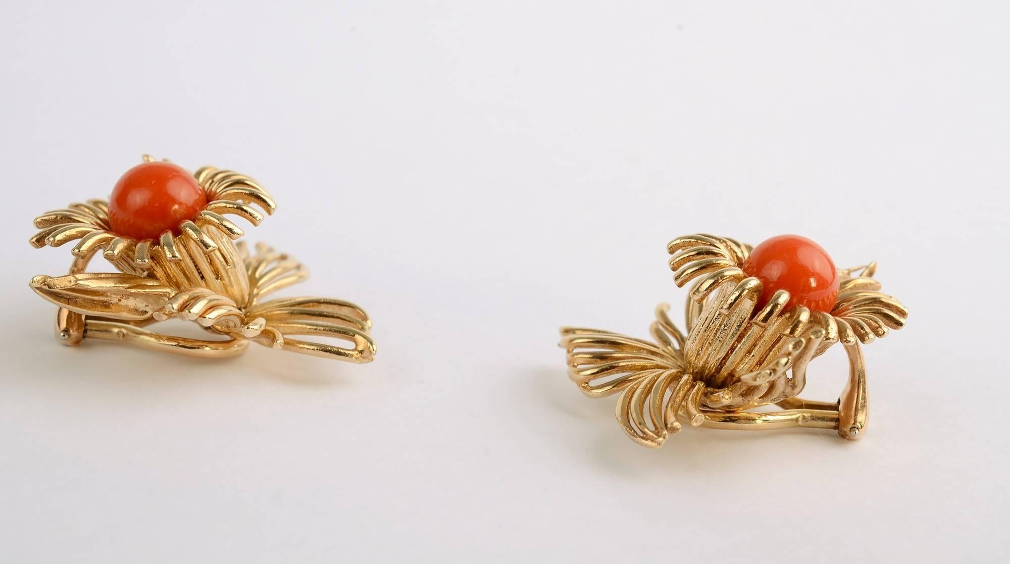 Graceful and airy floral earrings with a central cabochon coral stone, The earrings have wonderful dimensionality . Although they are 1 1/4 inches in all directions, they do not appear overly large because of their openness. Clip backs can be