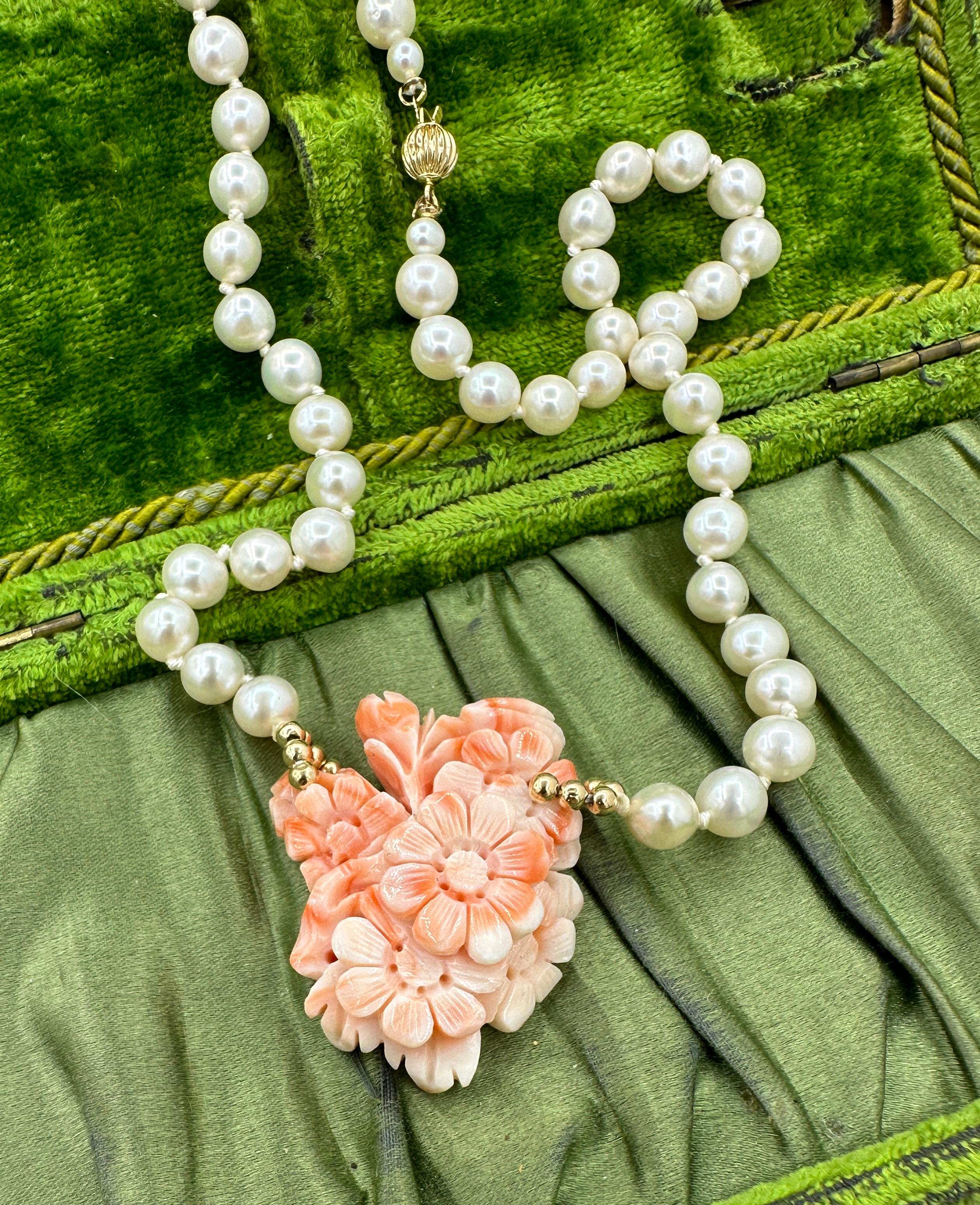 This is a stunning antique salmon colored Coral and Pearl Necklace with a beautiful hand carved Coral pendant in the form of a flower bouquet with flowers, buds and leaves.  The necklace is further set with 14 Karat Yellow Gold Beads and Clasp.  The