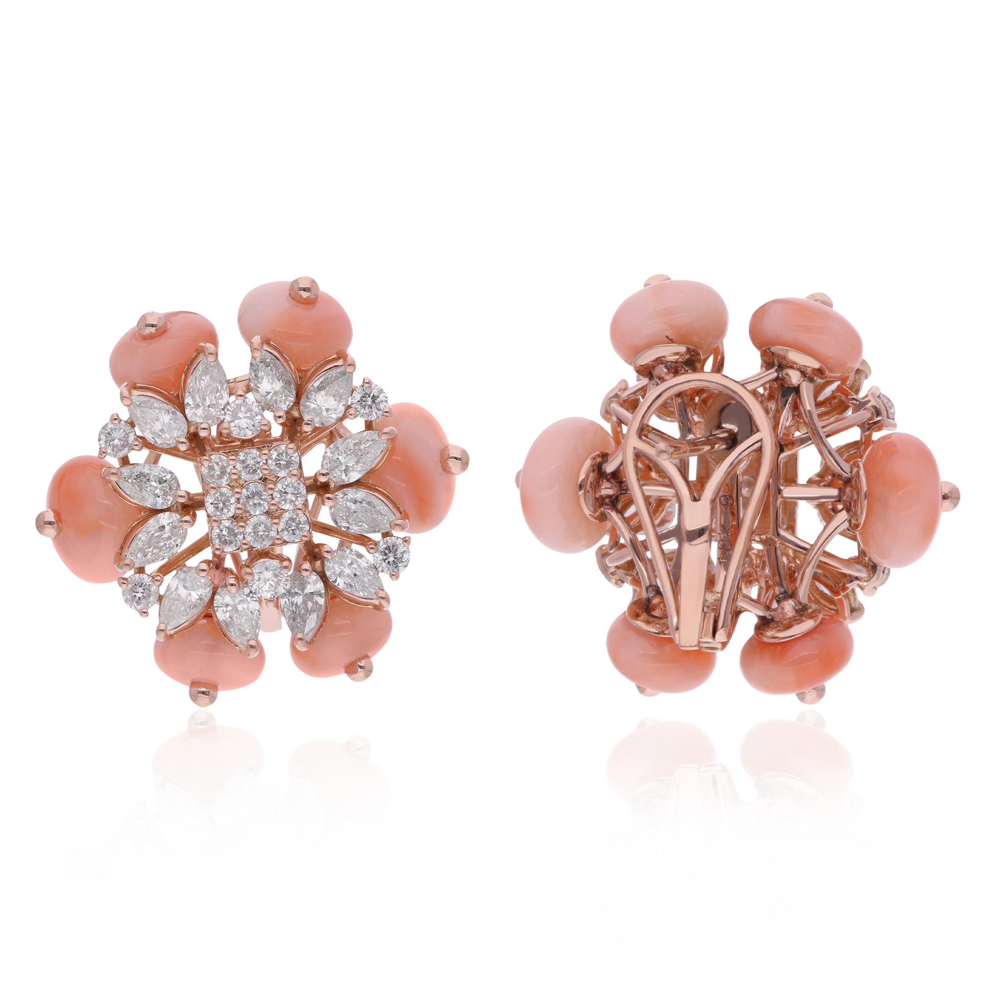 The 14 karat rose gold setting lends a warm and romantic hue to the ensemble, perfectly complementing the rich tones of the coral gemstones. The gentle curves of the marquise diamonds add a touch of grace and fluidity, while the brilliance of the