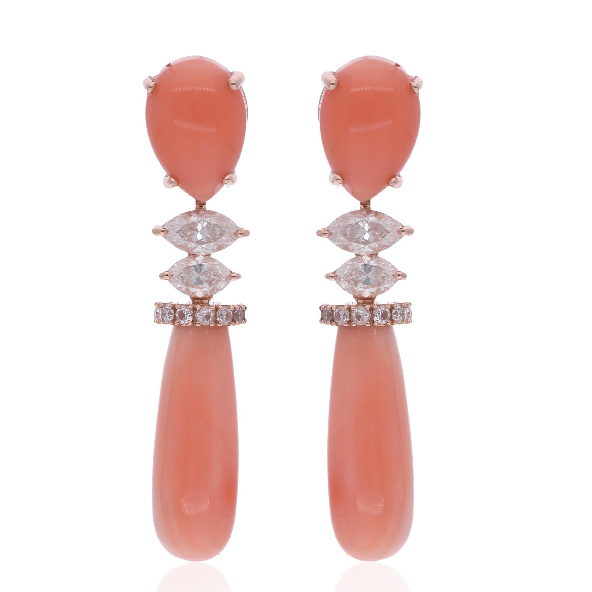 Delight in the allure of the sea with these Coral Gemstone Dangle Earrings, adorned with radiant Marquise Diamonds and meticulously crafted in luxurious 18 Karat Rose Gold. This exquisite pair of fine jewelry is a celebration of elegance and
