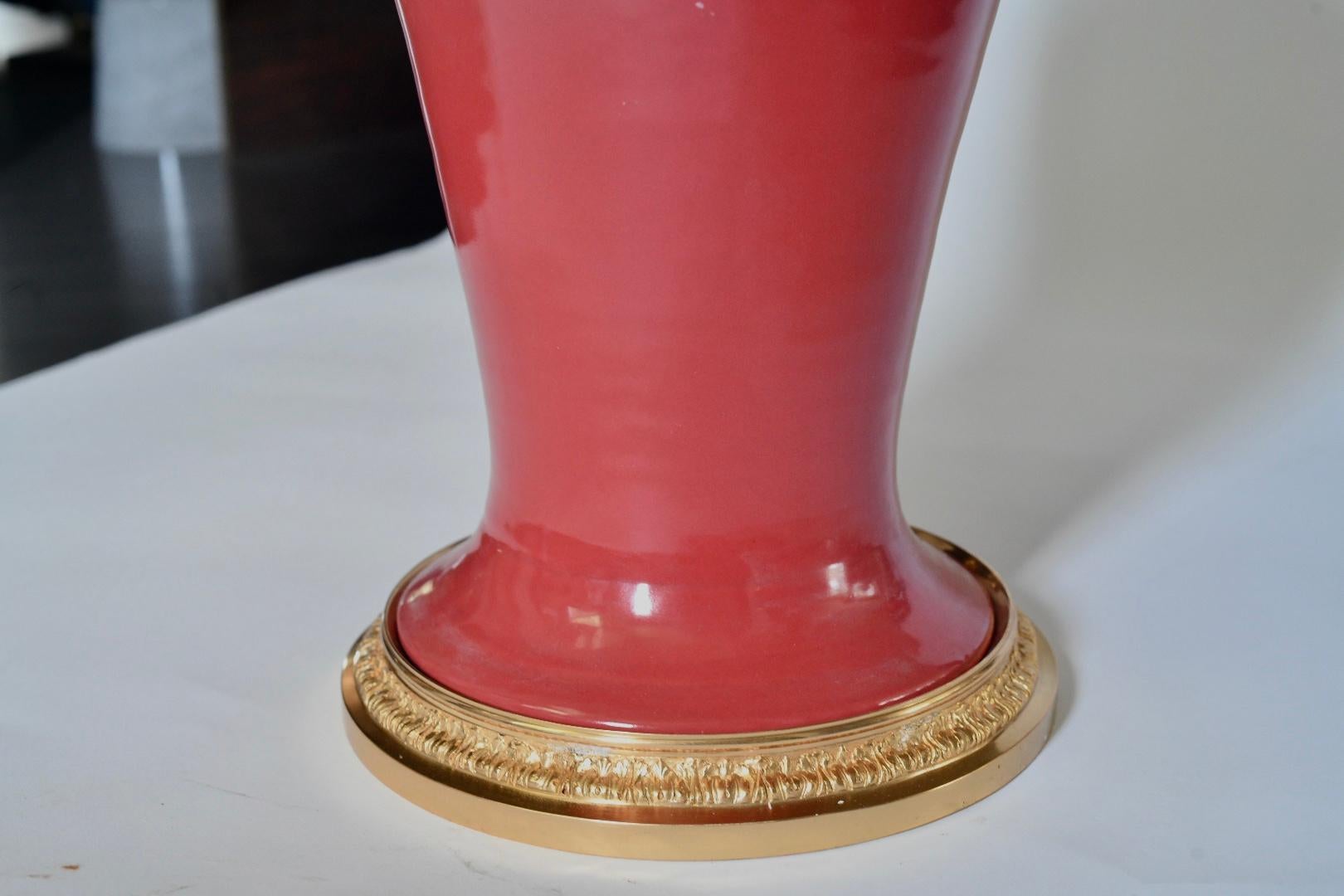 Pair of coral red glazed porcelain vases with fine cast gilt brass decoration mounted as lamps.
To the top of porcelain: 17.5