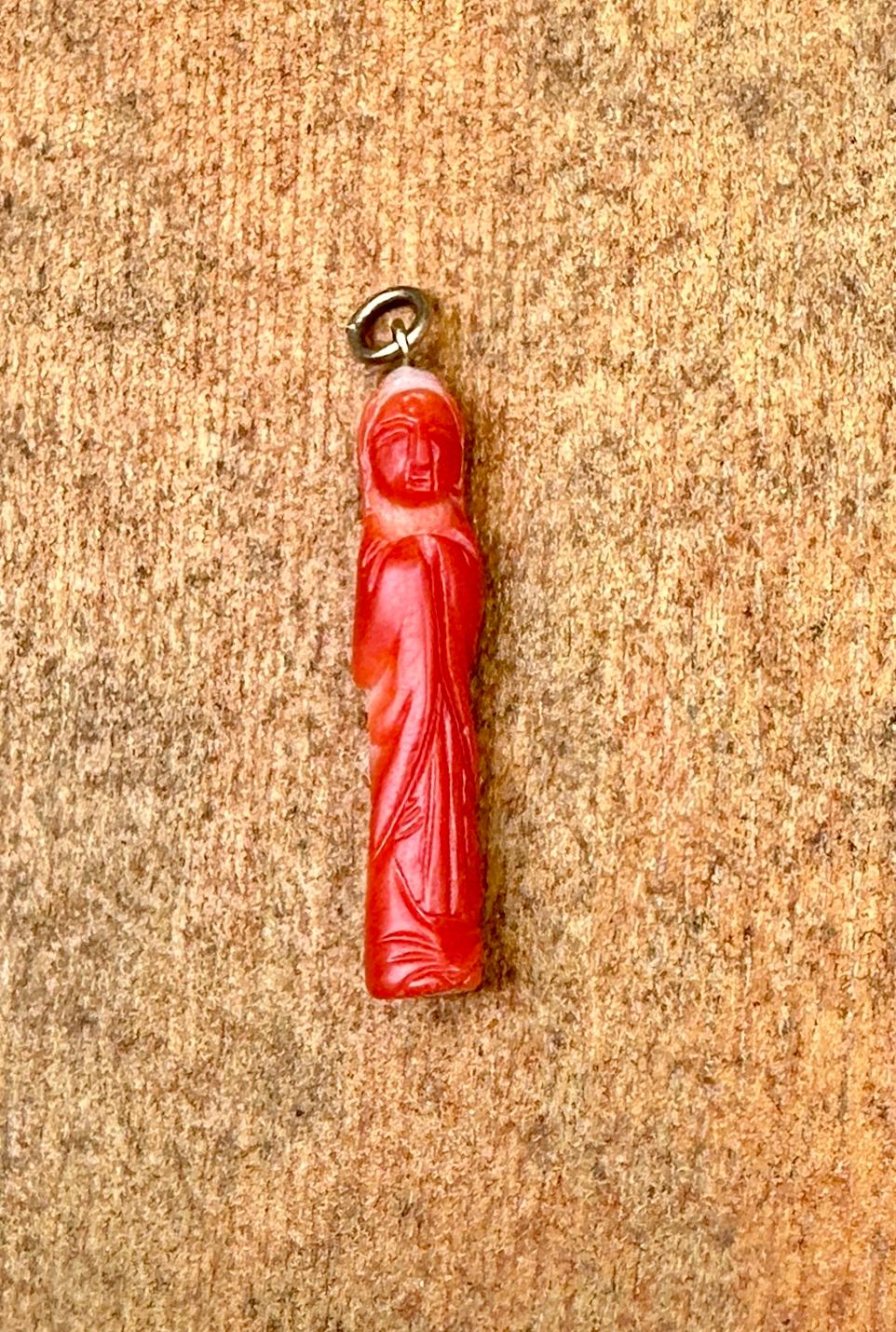 This is a wonderful antique Art Deco Salmon Pink Momo Coral Guan Yin Guanyin Pendant or Charm in 14 Karat Yellow Gold.  The Guan Yin Goddess is exquisitely carved in natural Pink Momo Coral.   The size of the Guan Yin is perfect to wear as a pendant