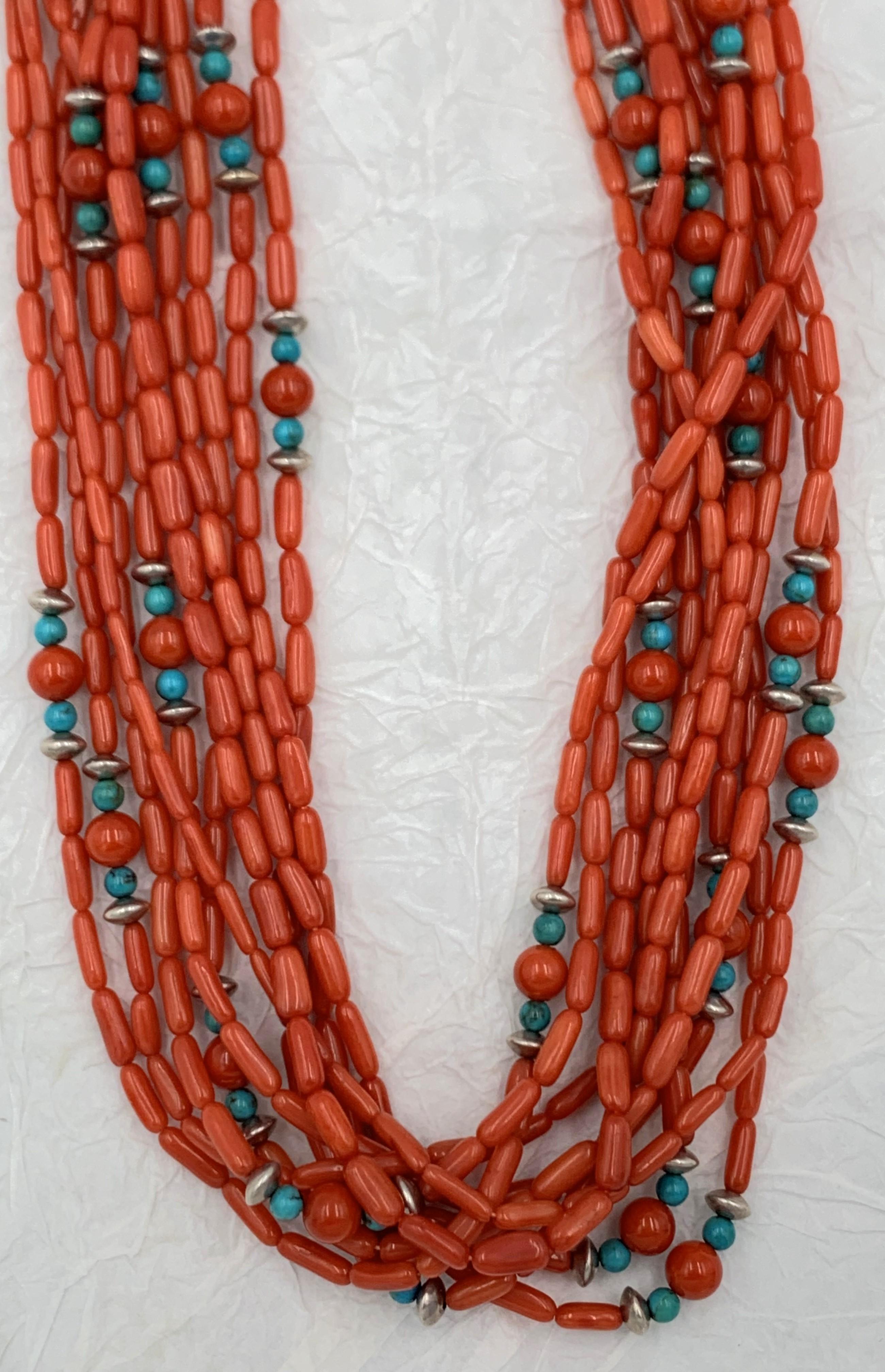 This beautiful necklace has 10 strands of natural coral beads in shades red-orange. Interspersed amongst the coral are turquoise stones and silver. 


#J1786 @ S