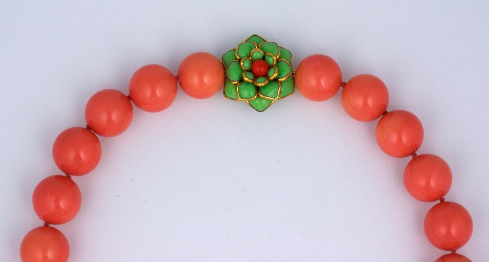 MWLC 20 mm. deep coral lacquer hand knotted beads with poured glass zinnia clasp in jade and  bright coral. Hand made in our studios in France. Length: 17.5