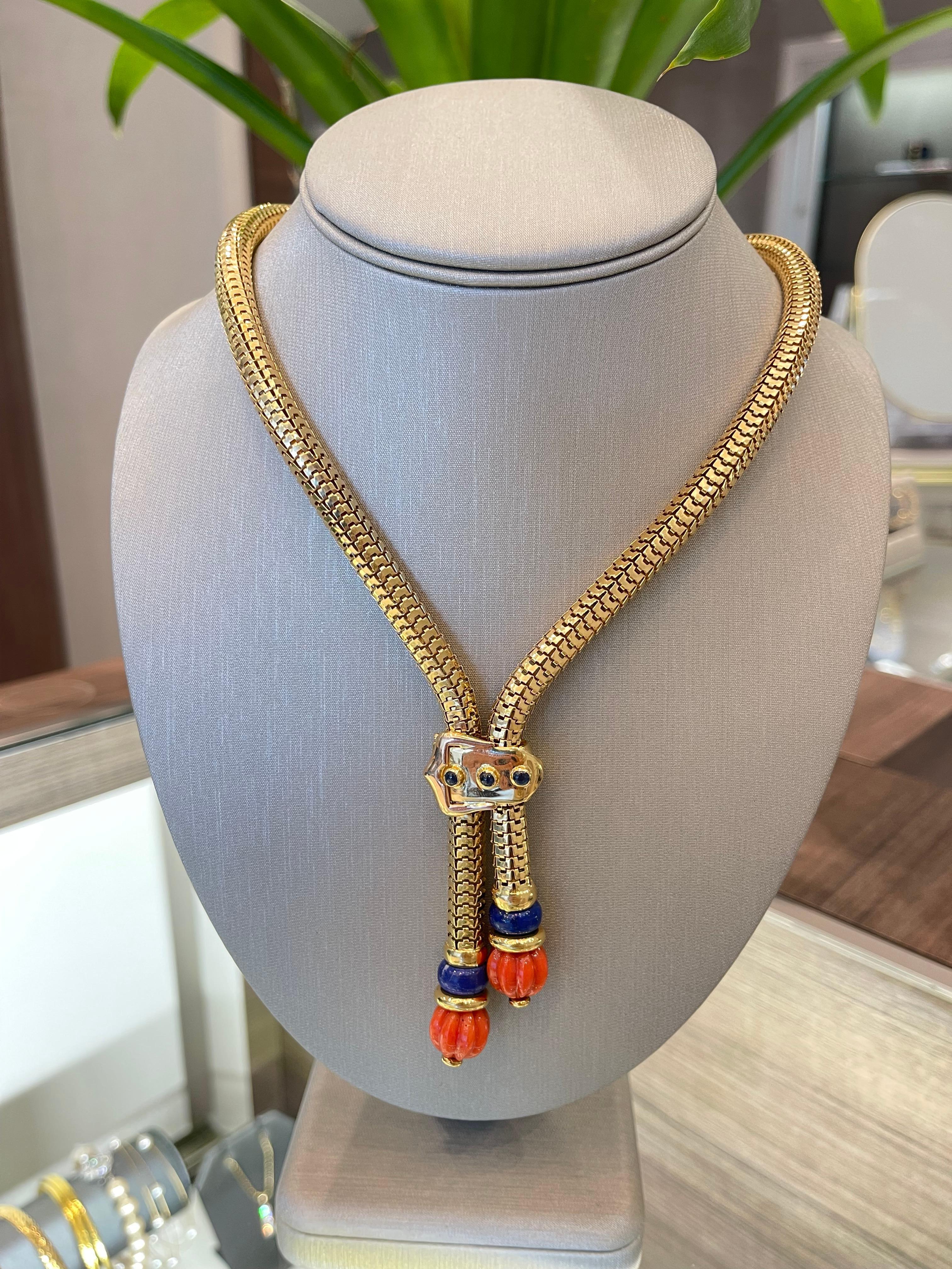 Coral & Lapis Lariat Necklace in 18K Yellow Gold. The necklace features two carved coral beads and lapis lazuli. The necklace fits like an 18