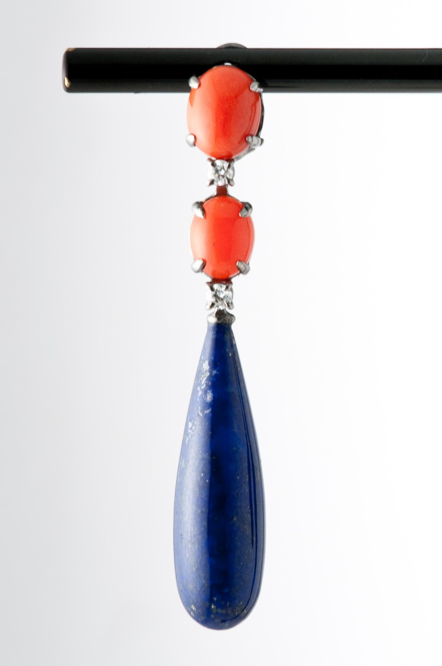 These cabochon coral and lapis lazuli chandelier earrings are a masterpiece of craftsmanship and design. The premium gemstones are carefully selected for their vibrant colour and timeless beauty.

The 0.32 carat diamonds add a touch of glamour and
