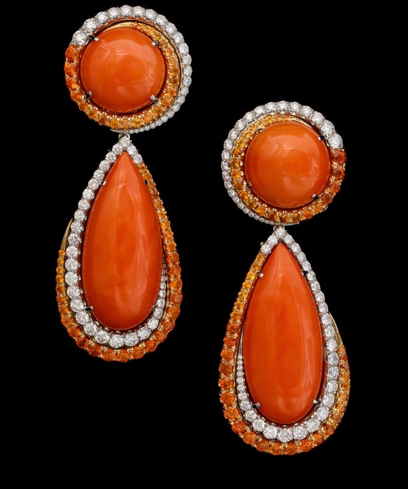 One of a kind earrings featuring impressively large coral buttons and drops surrounded by diamonds and mandarin garnets.  The mandarin garnets have been individually selected and set graduating from dark to light.  Handmade in one of New York's