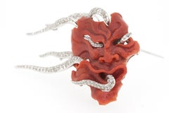 Coral Mask Brooch with White Diamond in White 18 Karat Gold