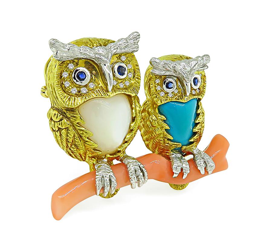 This is an amazing 18k yellow and white gold owl pin/pendant. The pin is set with multi color gemstones which are coral, mother of pearl, turquoise, diamonds and sapphires. The pin measures 37mm by 45mm and weighs 32.1 grams. The pin is stamped K18
