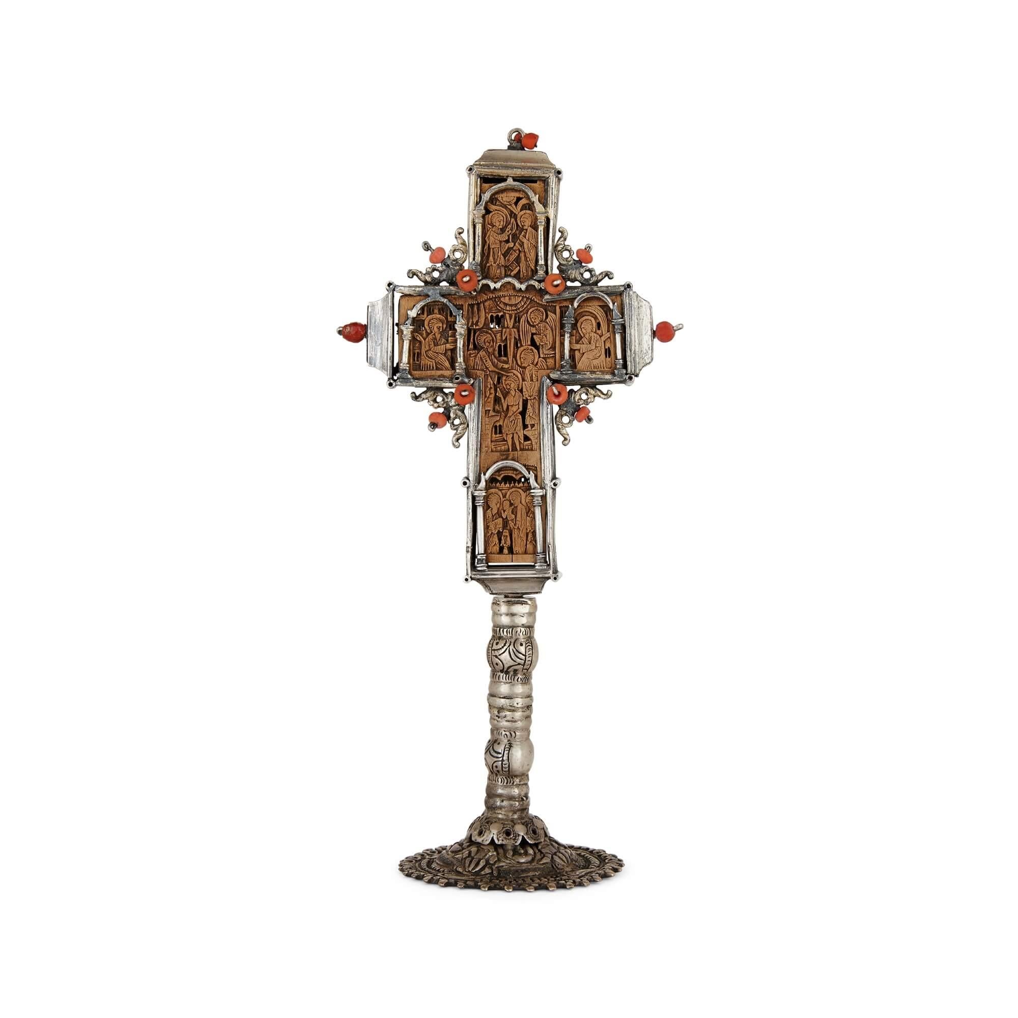 Antique Greek Orthodox carved wood and silver cross
Greek, 18th Century
Height 18.5cm, width 8.5cm, depth 6.5cm

This superb piece is a Greek Orthodox cross, crafted from silver, wood, and coral. The cross is comprised of a relief carved wooden