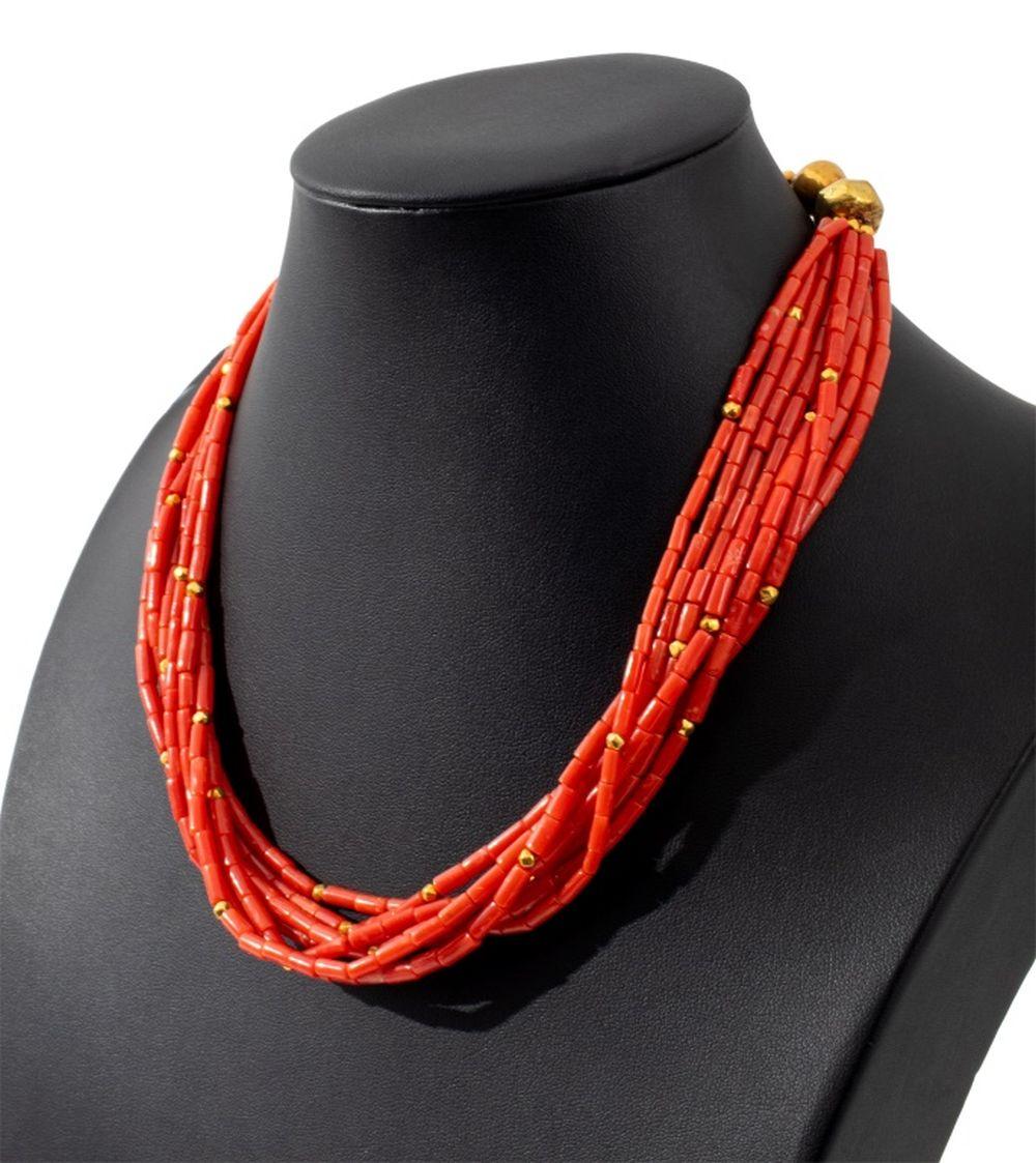 Red Coral Bead Multi-Strand Necklace, featuring eight strands strung on silk cord, with interspersed gold overlaid beads, joined with 18K yellow gold double hook and eye clasp. Gold tested.

 Measuring approx. 18 1/2