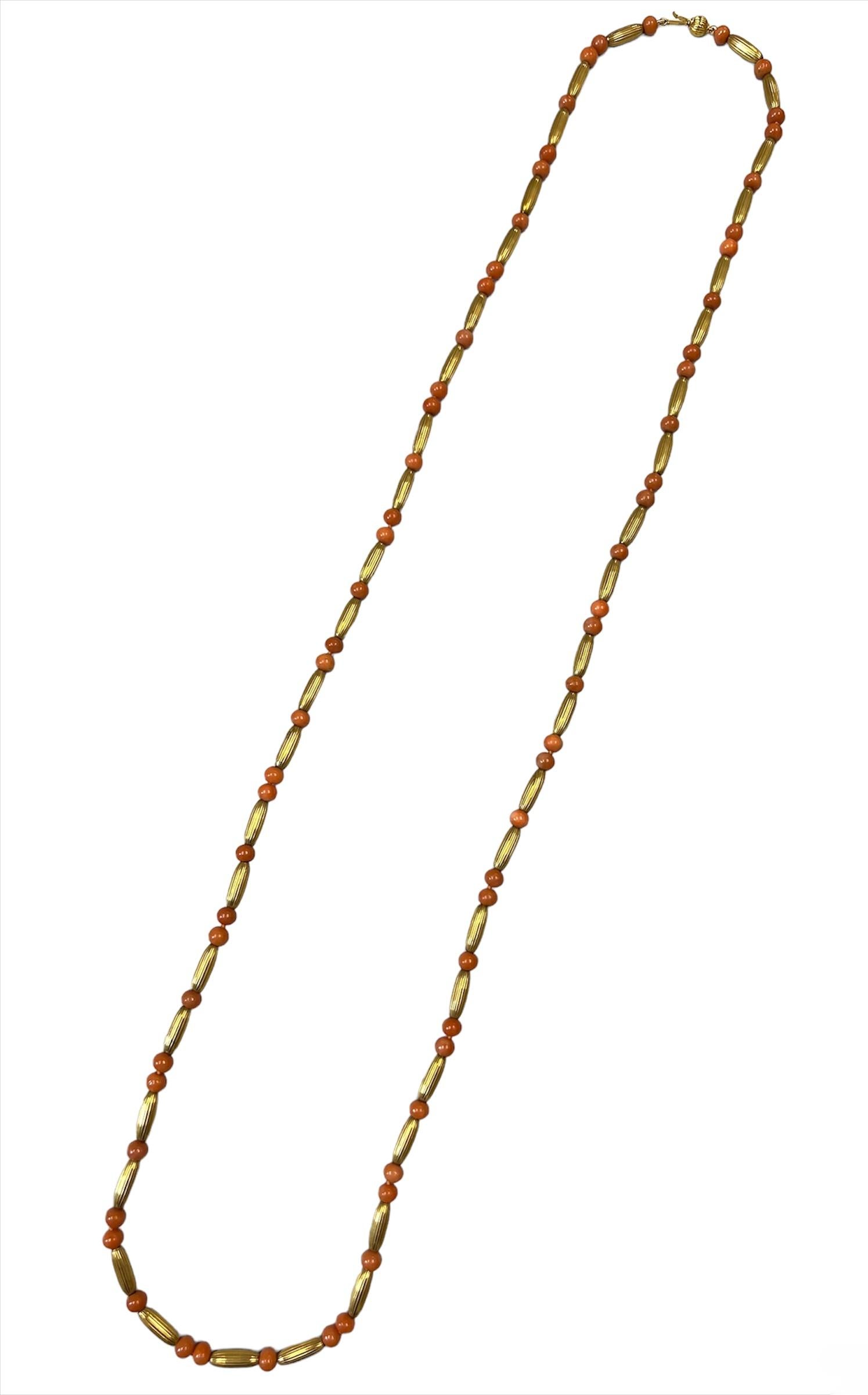 A fine coral necklace made in 14k gold, circa 1970s.

​The necklace features coral beads and textured hollow gold oval links.

The coral has a tender salmon pink color that matches well with the delicate gold hue.

This necklace has a perfect length