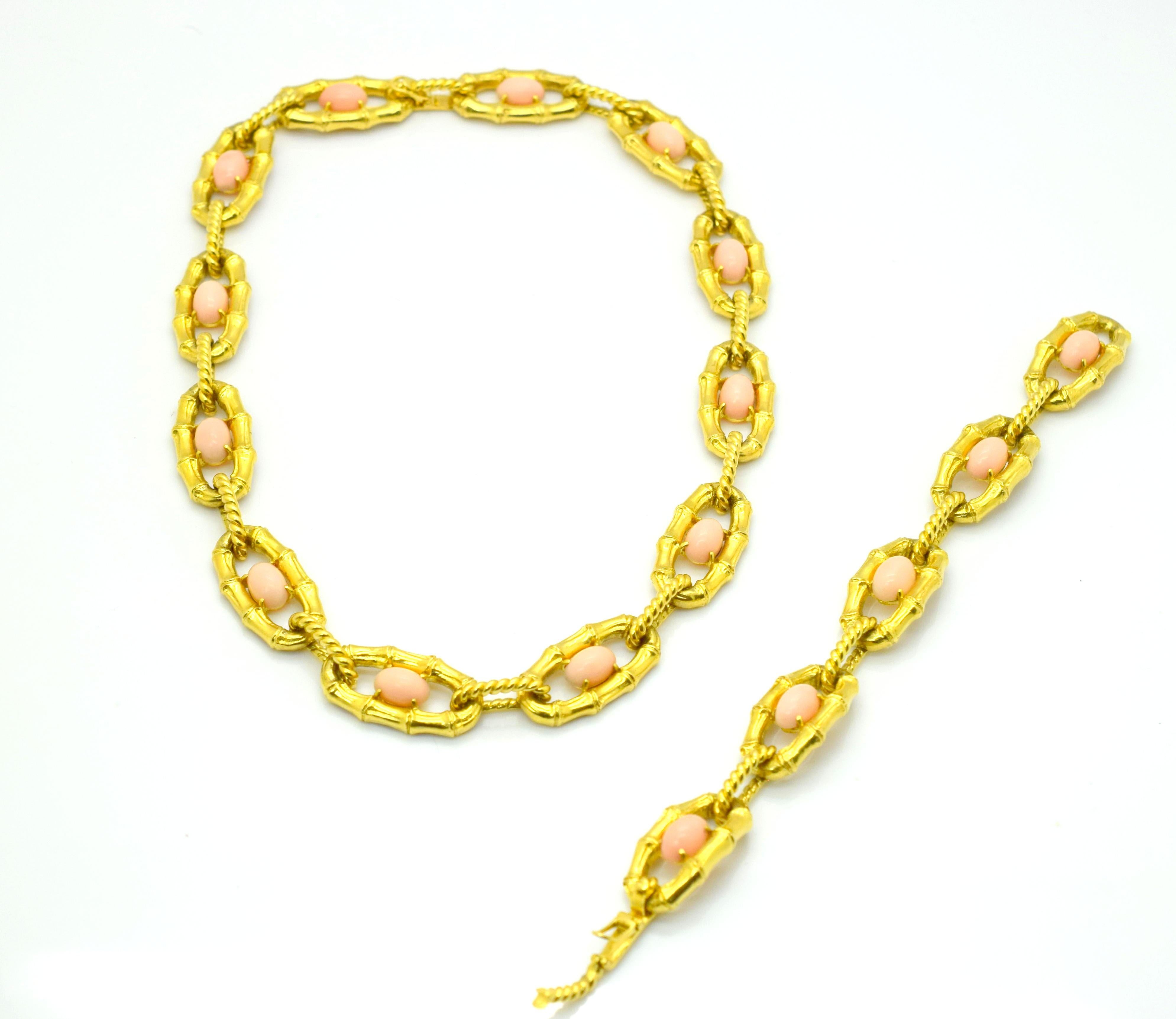 One of a kind necklace/bracelet crafted in 18k yellow gold. This amazing piece was crafted by masters of their time. The piece shows braided and bamboo motif links, each link is centered by a light pink Coral  