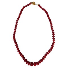 Coral necklace with gold setting.