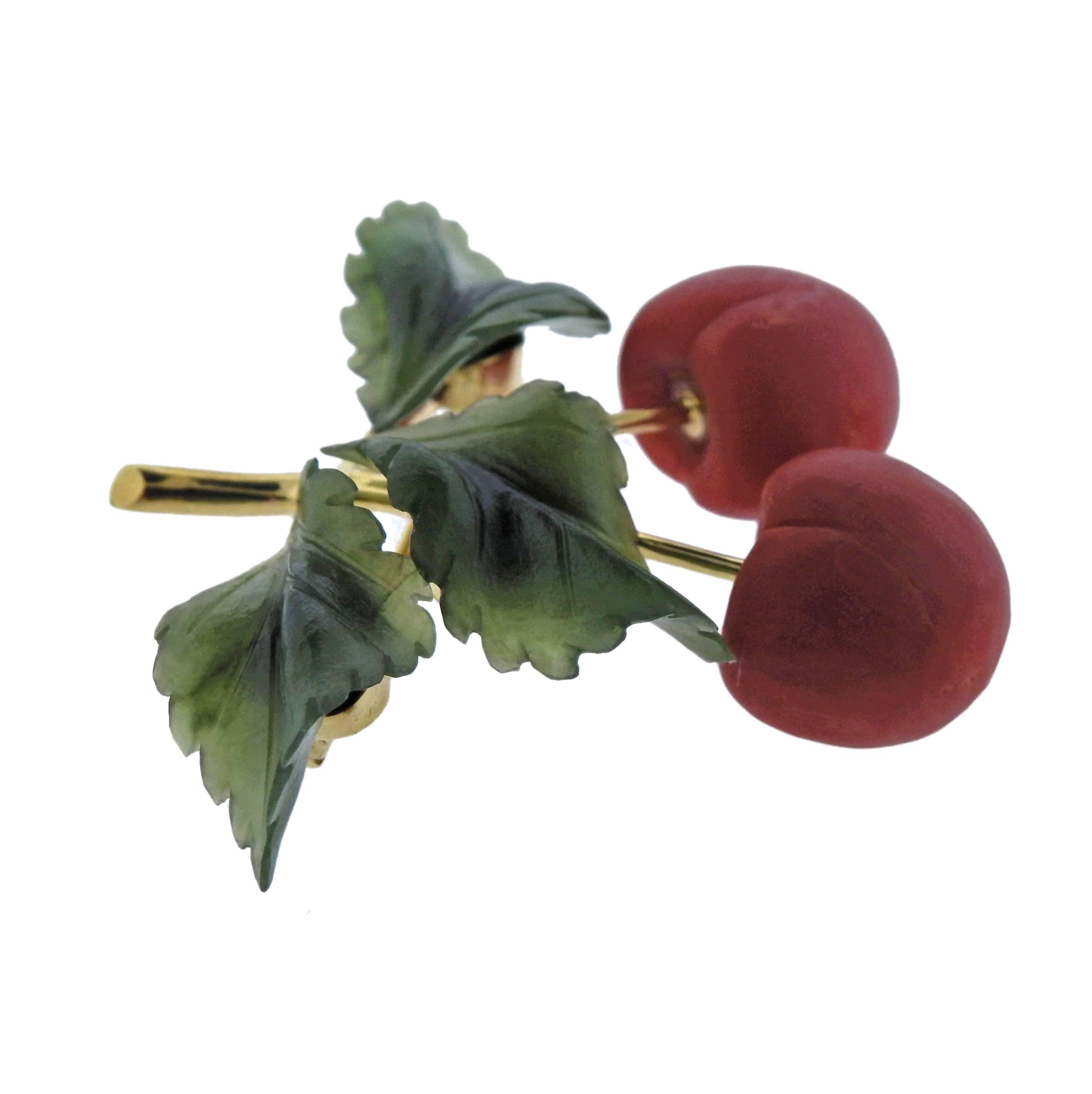  Adorable 18k gold cherry brooch, decorated with carved nephrite and coral gemstones. Brooch is 42mm x 45mm, weighs 12.3 grams. Marked: 750, F-G.