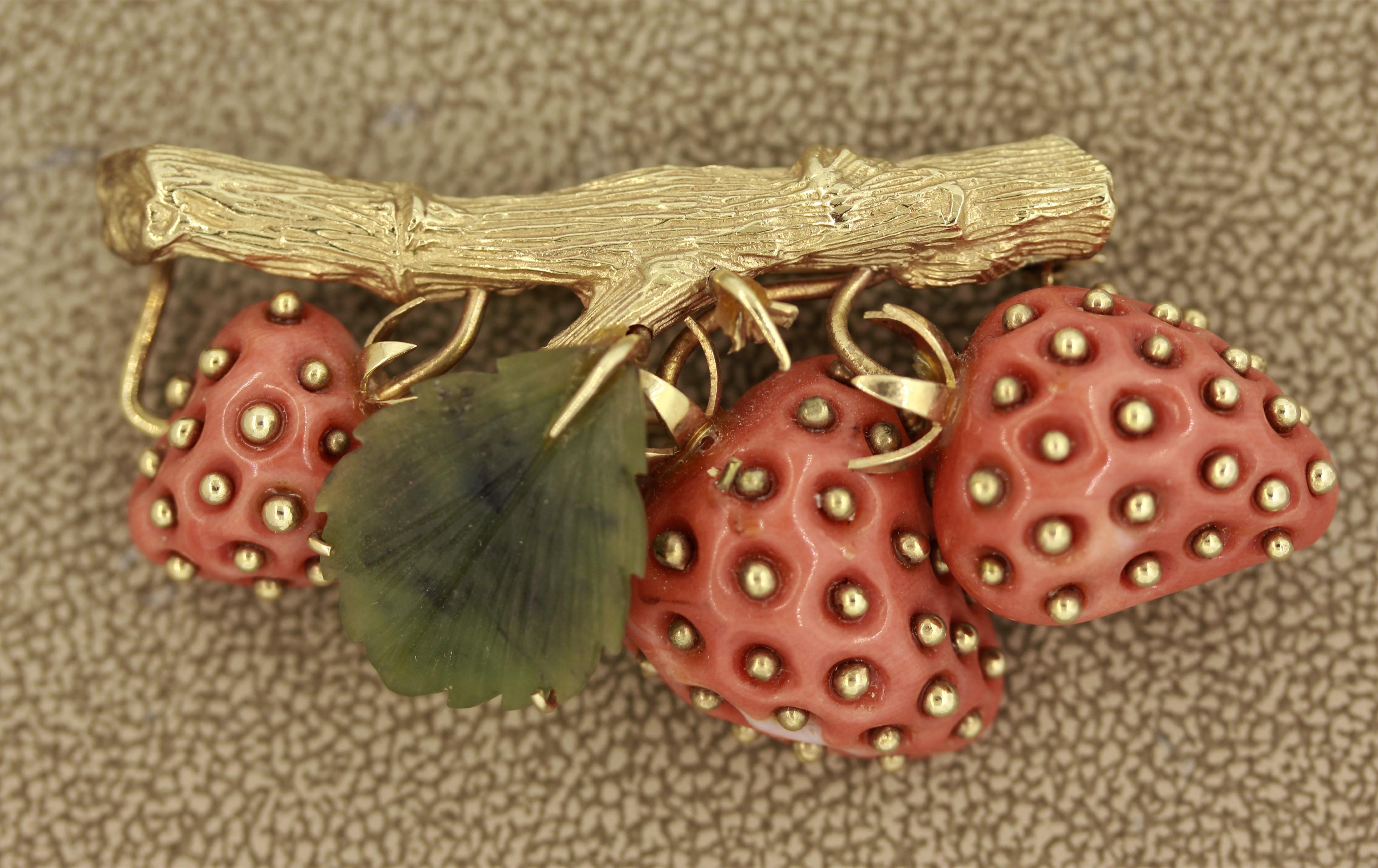 As cute as can be… This lifelike brooch depicting fresh strawberries is made of 3 pieces of natural coral which are studded with 18k gold. The leaf is made of natural nephrite which was hand carved. The branch was hand-fabricated in 18k yellow gold
