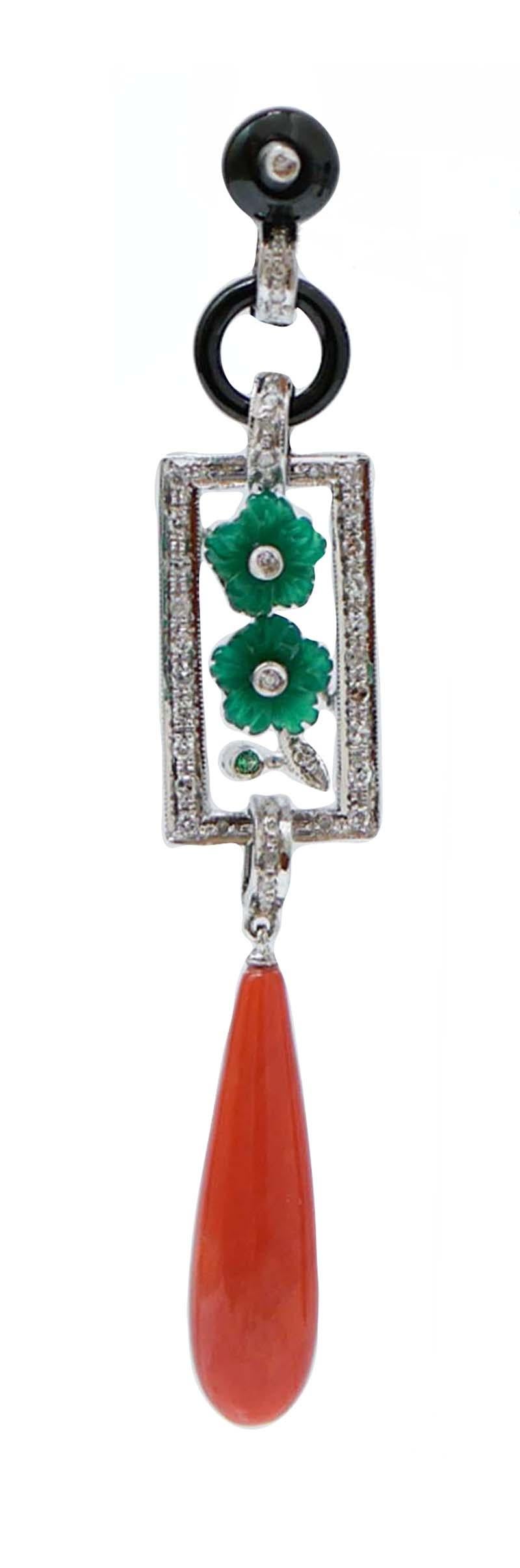 Fantastic earrings in platinum structure mounted with an onyx with a diamond in the upper part; in the middle, a structure mounted with diamonds and in the central part, flower of green agate. As pendant, a drop coral.
These earrings were totally