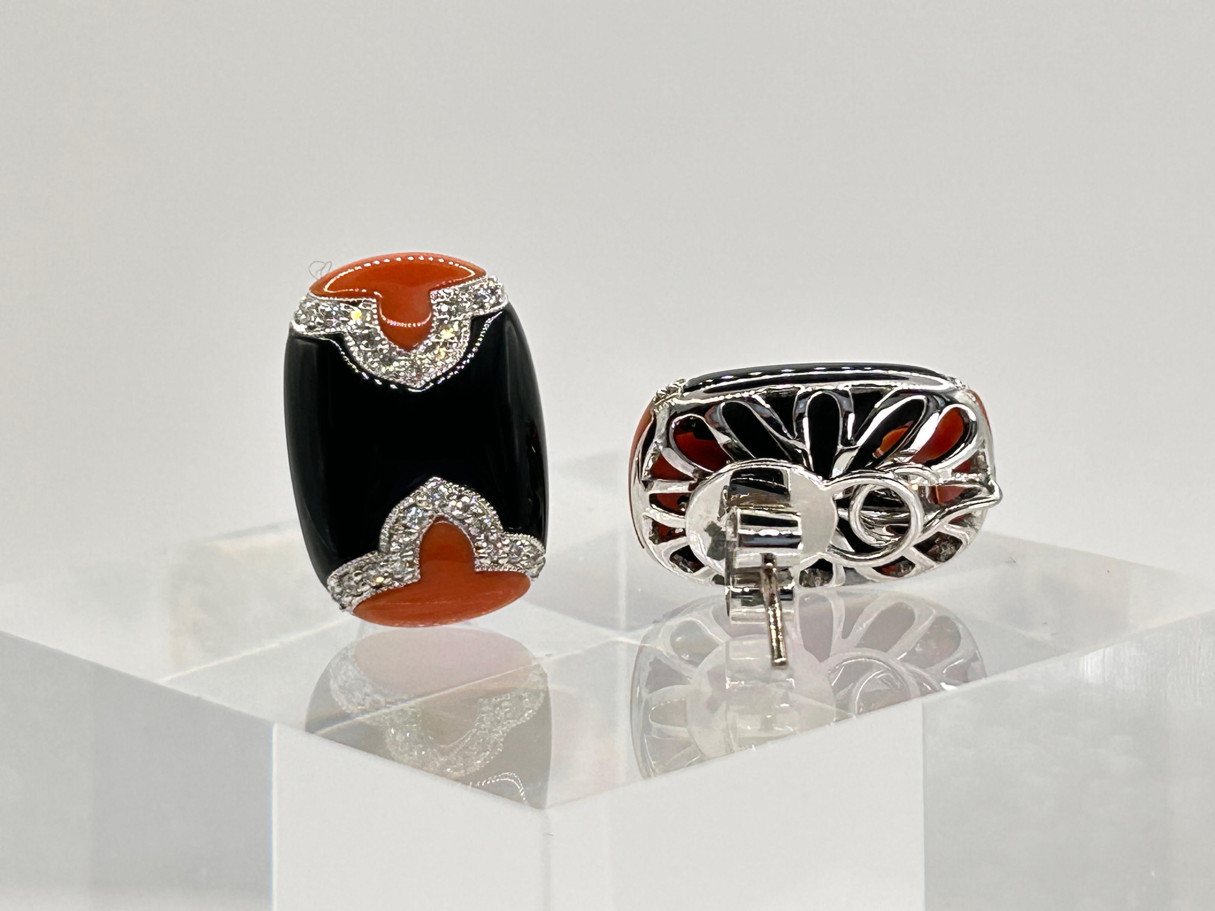 Striking Combination of Colors!

18 Karat White Gold Earrrings, set with reddish pink Coral, Onyx and Full Cut Diamonds weighing 0.32 Carat.  
