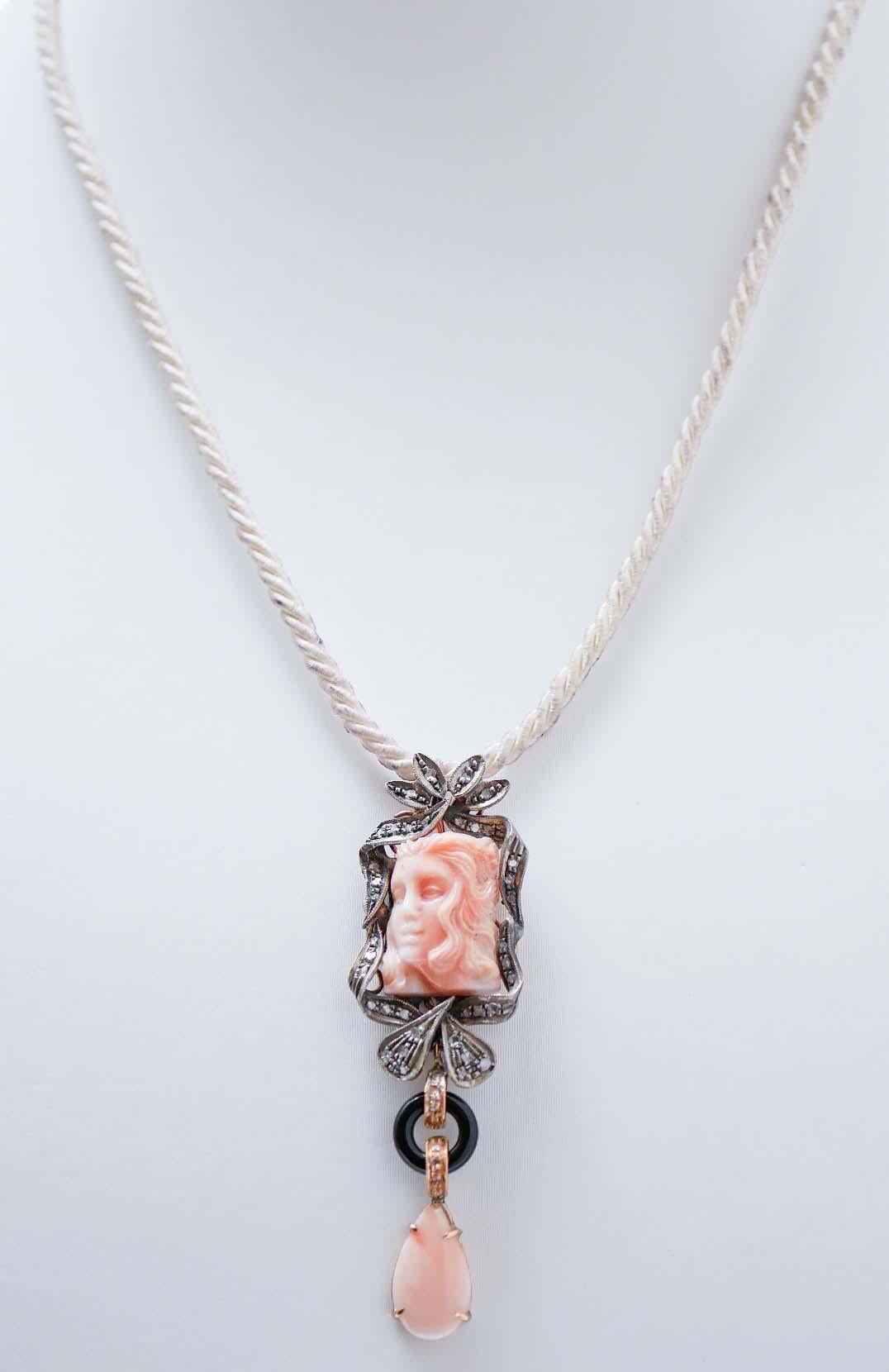 Fantastic pendant in 14 kt rose gold and silver structure mounted with a carved coral representing a lady motif surrounded by a frame of diamonds.  Below, an onyx between two structures studded with diamonds and, as pendant, a drop coral. The