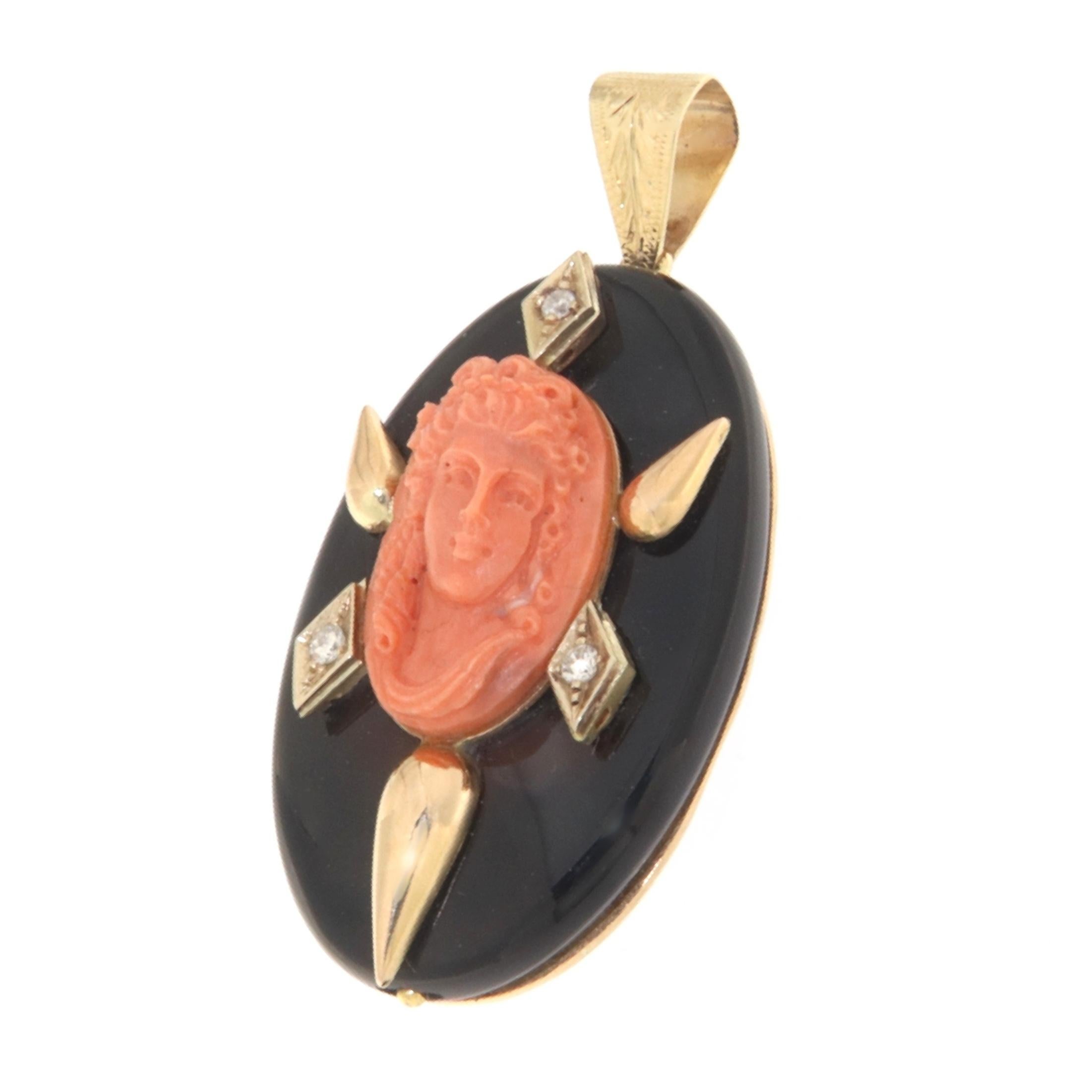 This 14-karat yellow gold pendant is a stunning display of classical elegance and contemporary finesse. It features a beautifully carved coral woman's face, a traditional cameo that exudes timeless grace. The cameo is set against a sleek, round onyx
