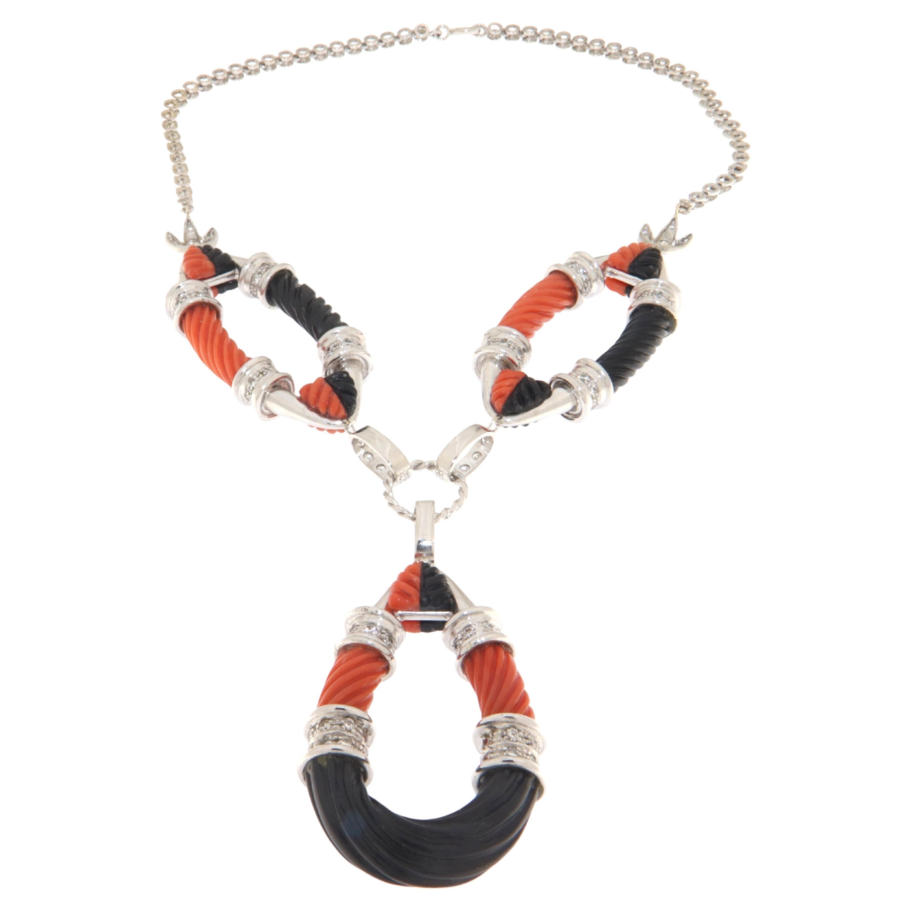 This striking necklace is a masterpiece of design, exquisitely crafted from 18-karat white gold and adorned with the vivid contrast of coral and onyx, highlighted by the sparkling brilliance of diamonds. It's a piece that not only stands out due to
