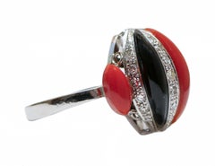Coral, Onyx, Diamonds, Platinum Ring.