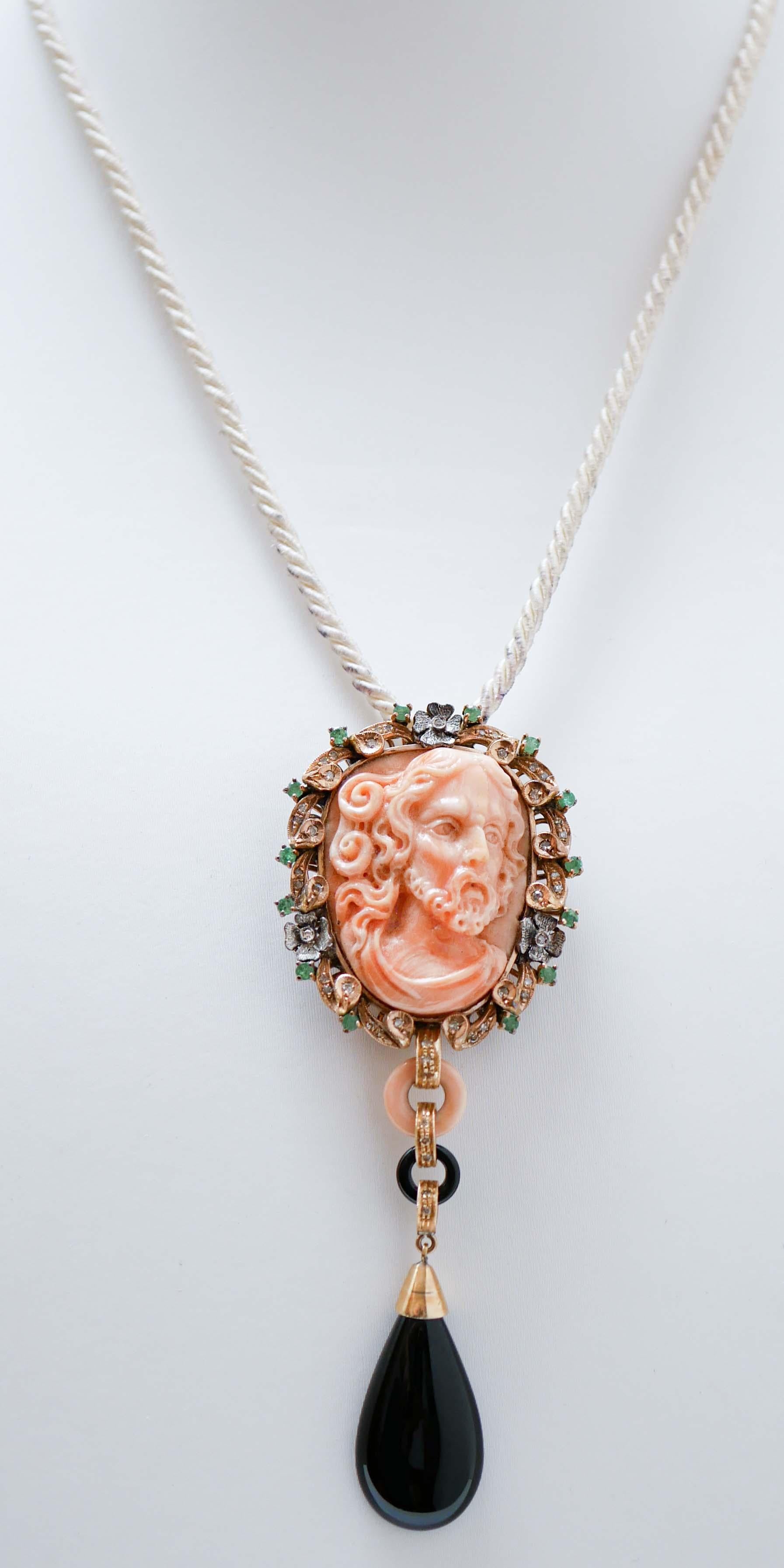 Fantastic pendant in 14 kt rose gold and silver structure mounted with a central carved coralsurrounded by a frame of diamonds and emeralds. . Below, a coral and onyx ring and, as pendant, a drop onyx.
This pendant was totally handmade by Italian
